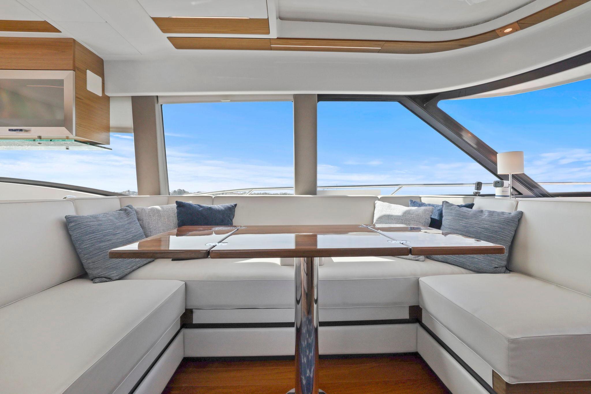 Luxurious interior of 2023 Tiara Yachts C49 Coupe with elegant seating and panoramic windows.