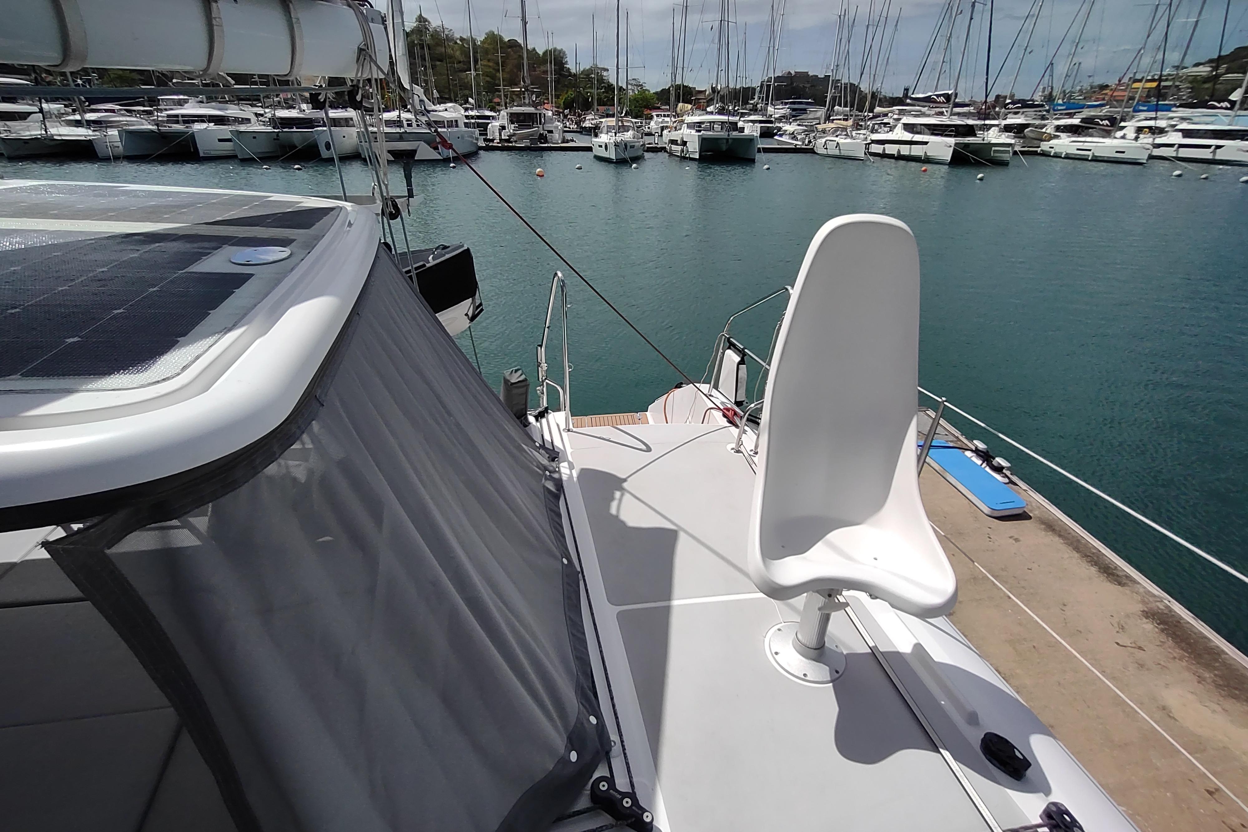 2020 Outremer 51 catamaran docked at marina, featuring sleek deck and modern design.