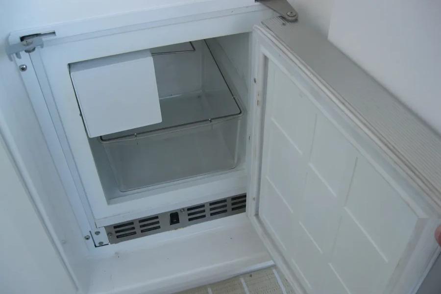 Open refrigerator compartment in a 2008 Doral Alegria boat, showing interior storage space.