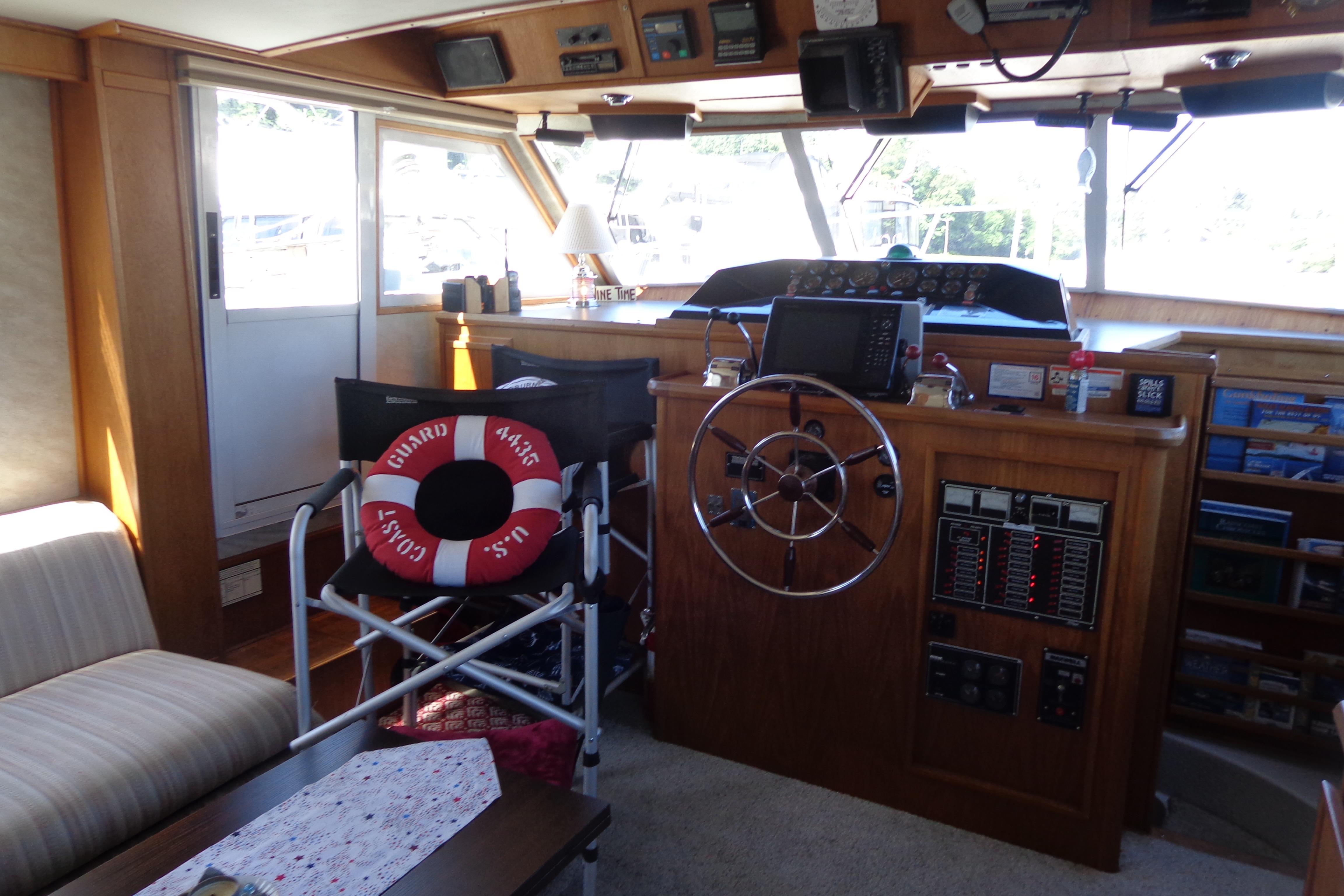 Interior of 1992 Cruise-A-Home Corsair 4200 boat with helm, controls, and seating area.