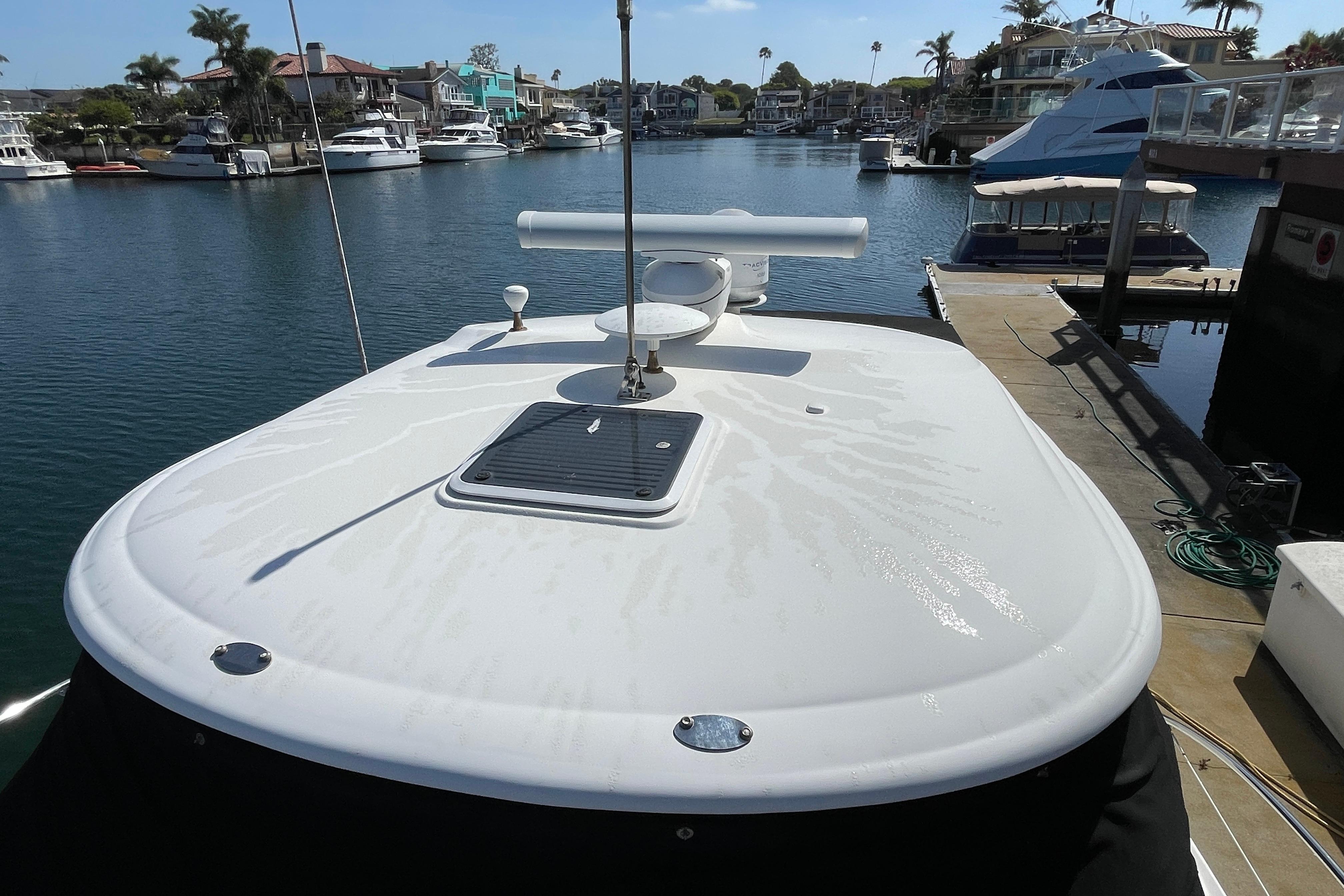 2007 Sea Ray 440 Express yacht docked in a marina, showcasing sleek deck design.