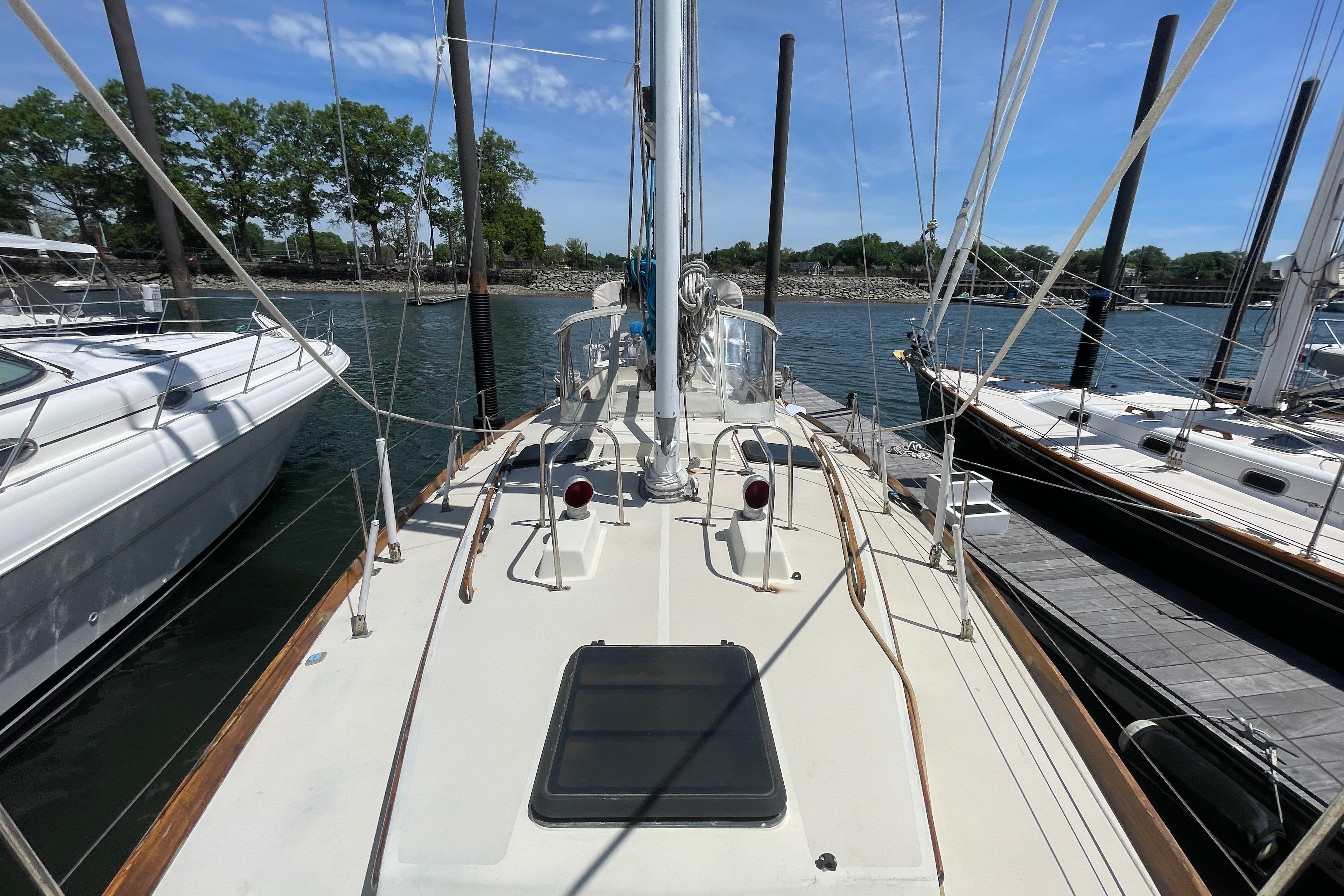 1981 Bristol 41.1 Center Cockpit sailboat docked at marina, clear sky, calm water.