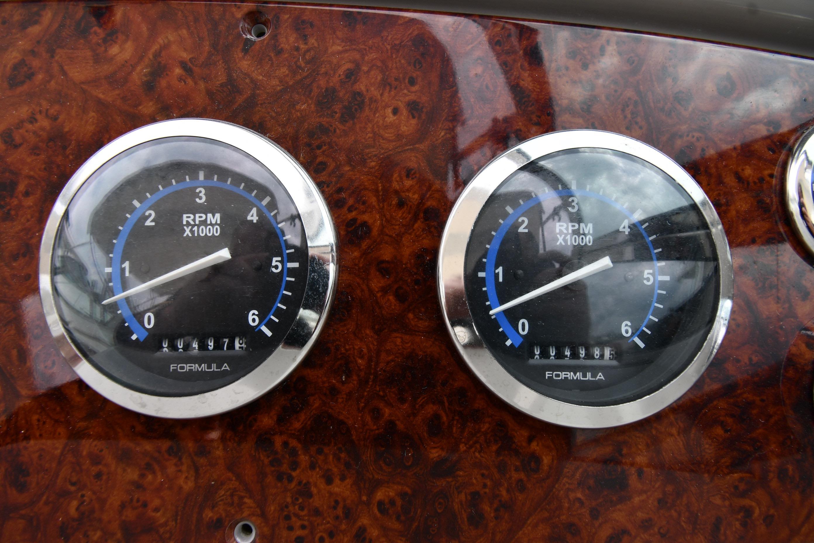 Dashboard of a 2004 Formula 330 Sun Sport with RPM gauges.