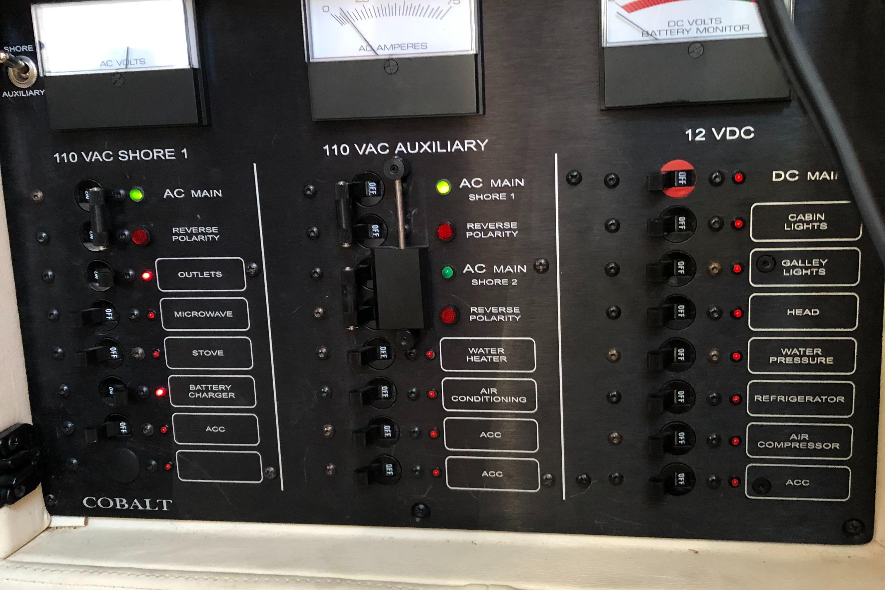 Electrical control panel of a 2005 Cobalt 360 boat, featuring various switches and indicators.