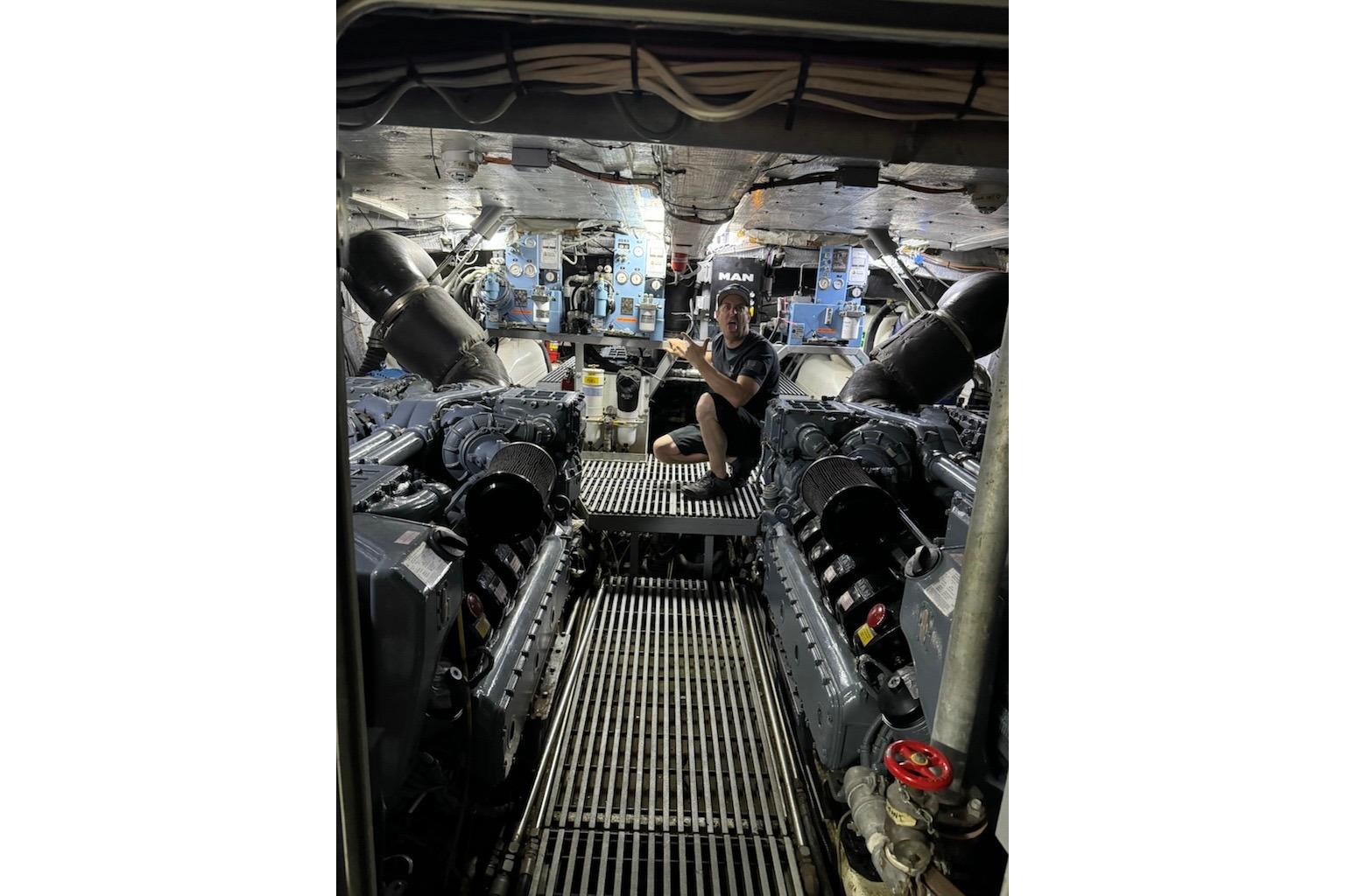 Engine room of 2012 River Hawk 73 Sea Stryker Fast Patrol Boat with technician.