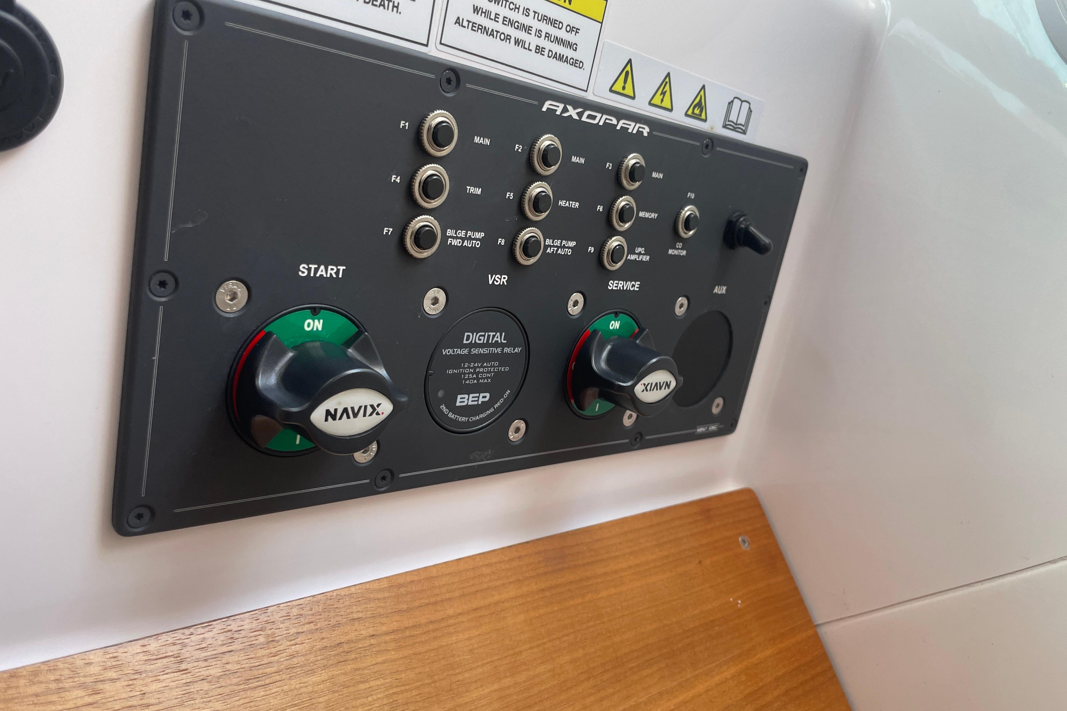Control panel of 2022 Axopar Brabus 28 Cabin boat with switches and knobs.