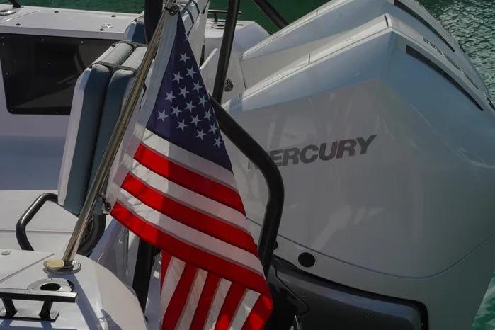 American flag on 2023 Axopar 37 XC Cross Cabin with Mercury engine.