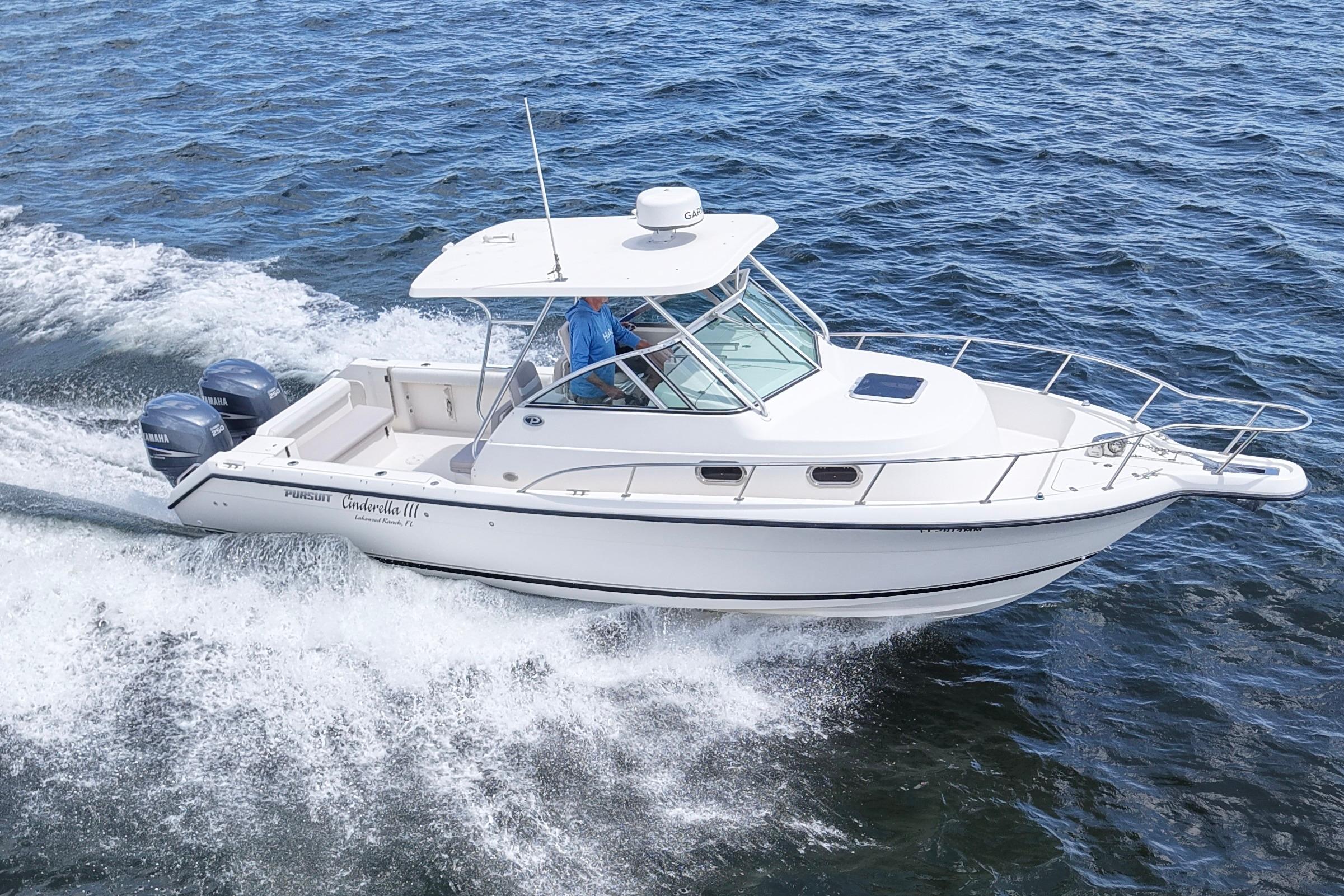 2004 Pursuit 2870 Walkaround boat cruising on open water, featuring twin engines.