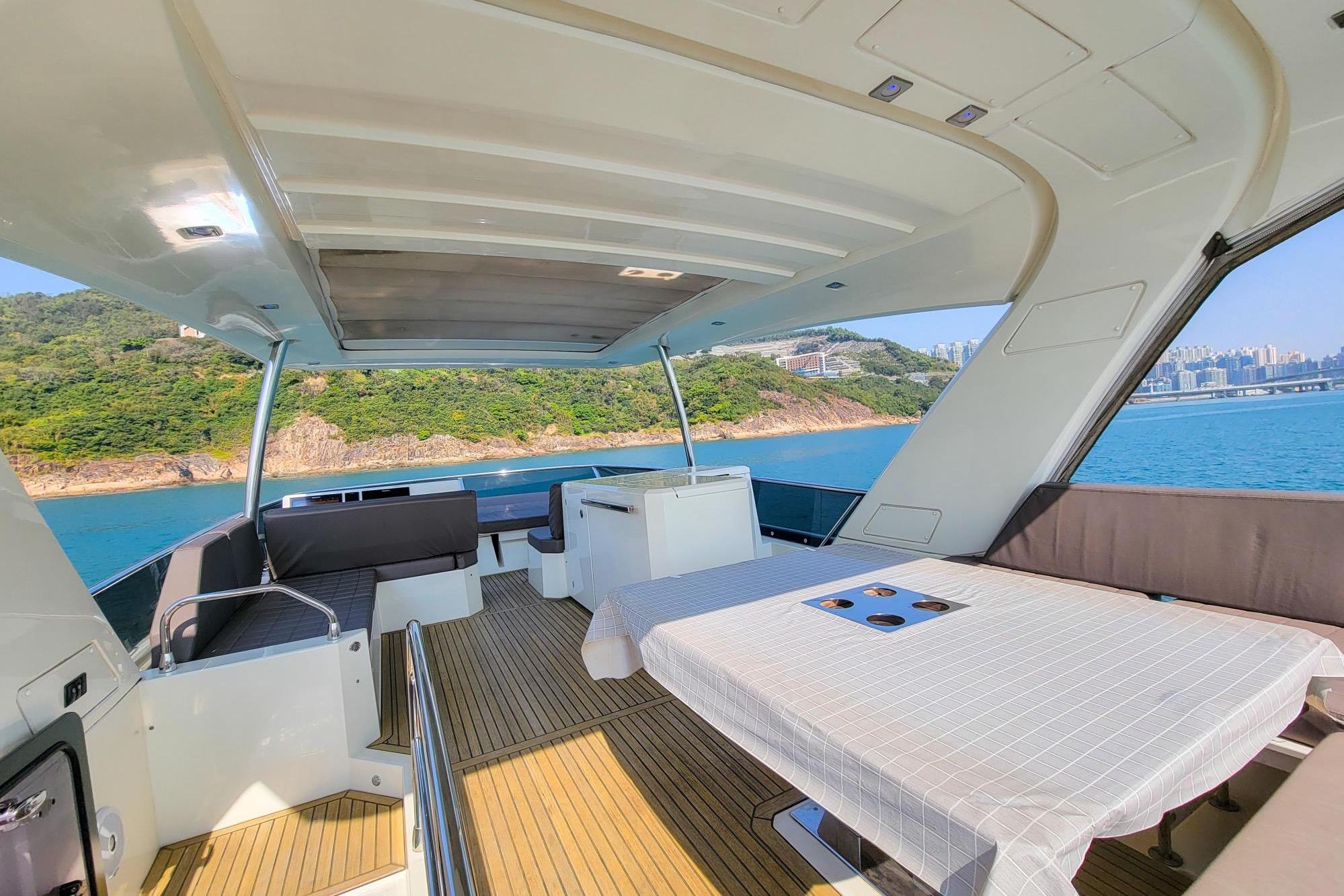 Luxurious 2019 Prestiage 630 yacht interior with scenic ocean and coastal views.