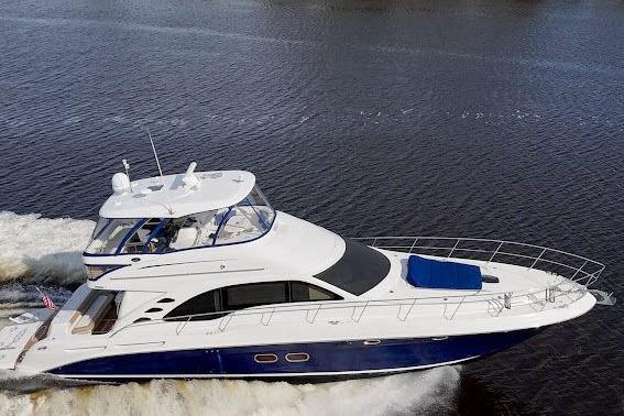 2006 Sea Ray 580 Sedan Bridge yacht cruising on open water, showcasing sleek design and luxury.