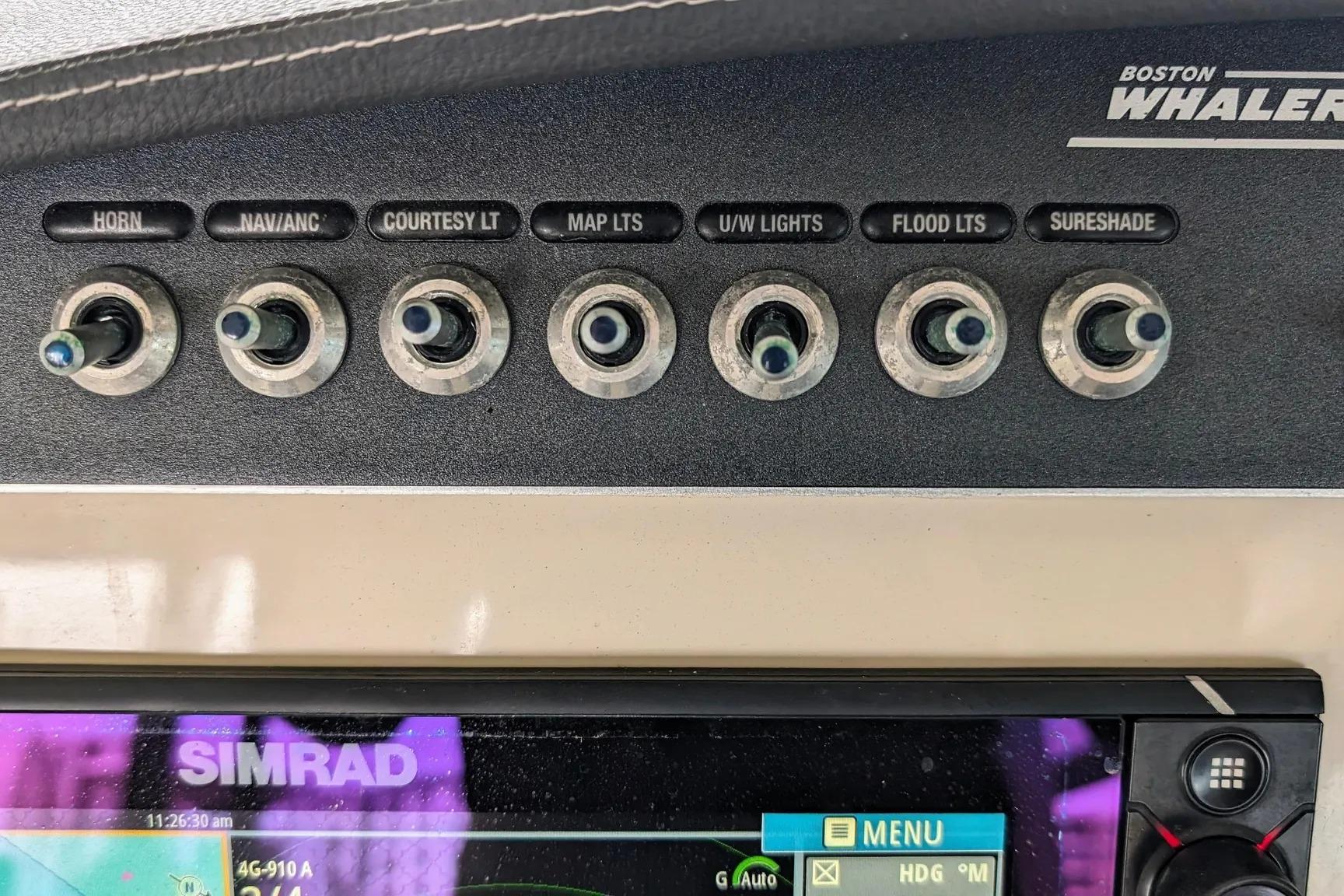 Control panel of a 2017 Boston Whaler 320 Vantage boat with labeled switches.