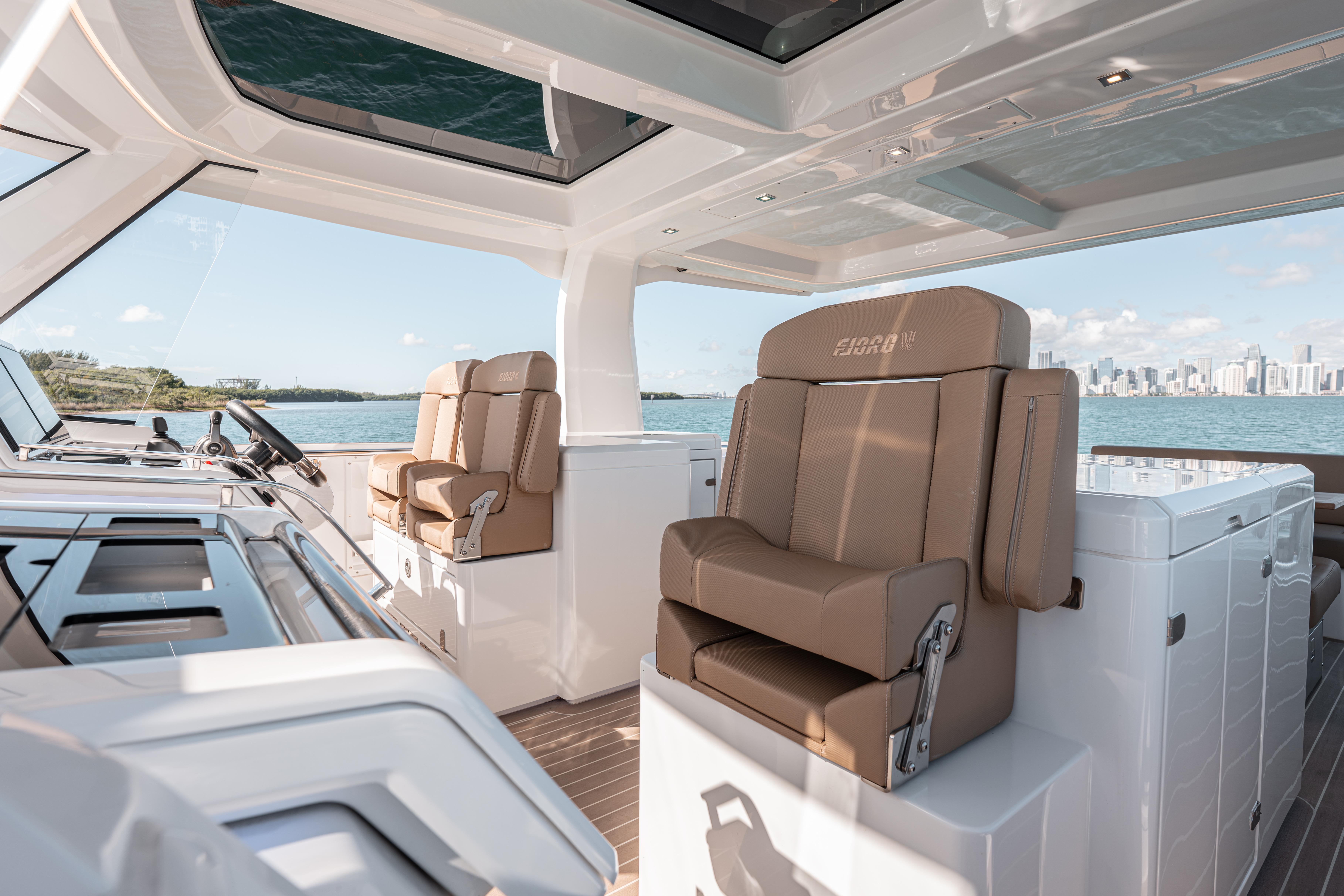 Luxurious interior of 2024 Fjord Boats 53XL with panoramic views and plush seating.