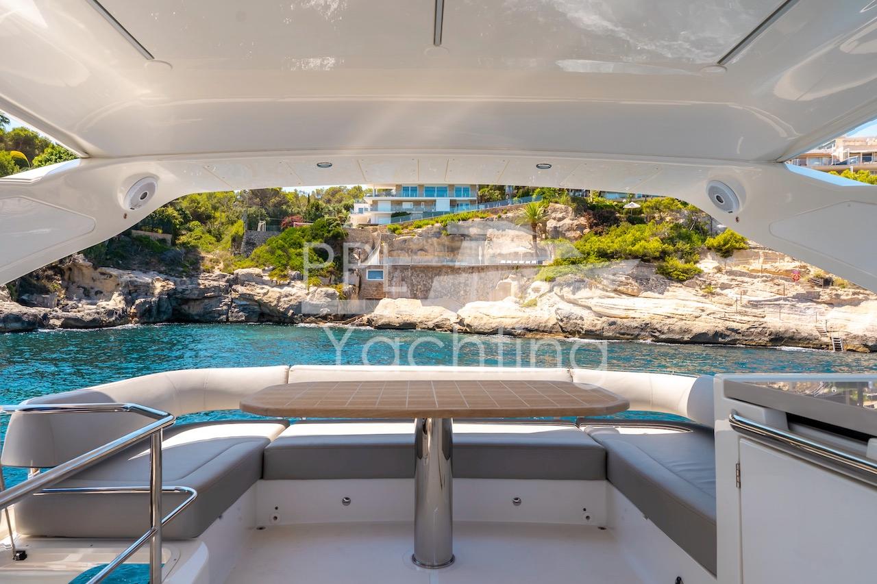 2021 Absolute 47 Fly yacht interior with scenic coastal view.