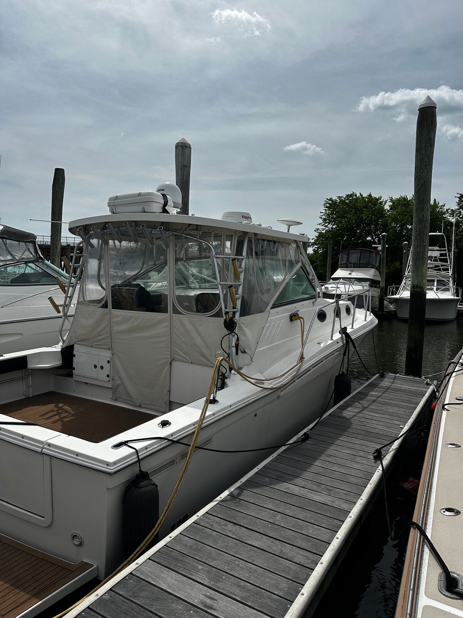 A 2005 Wellcraft 330 Coastal boat docked at a marina.