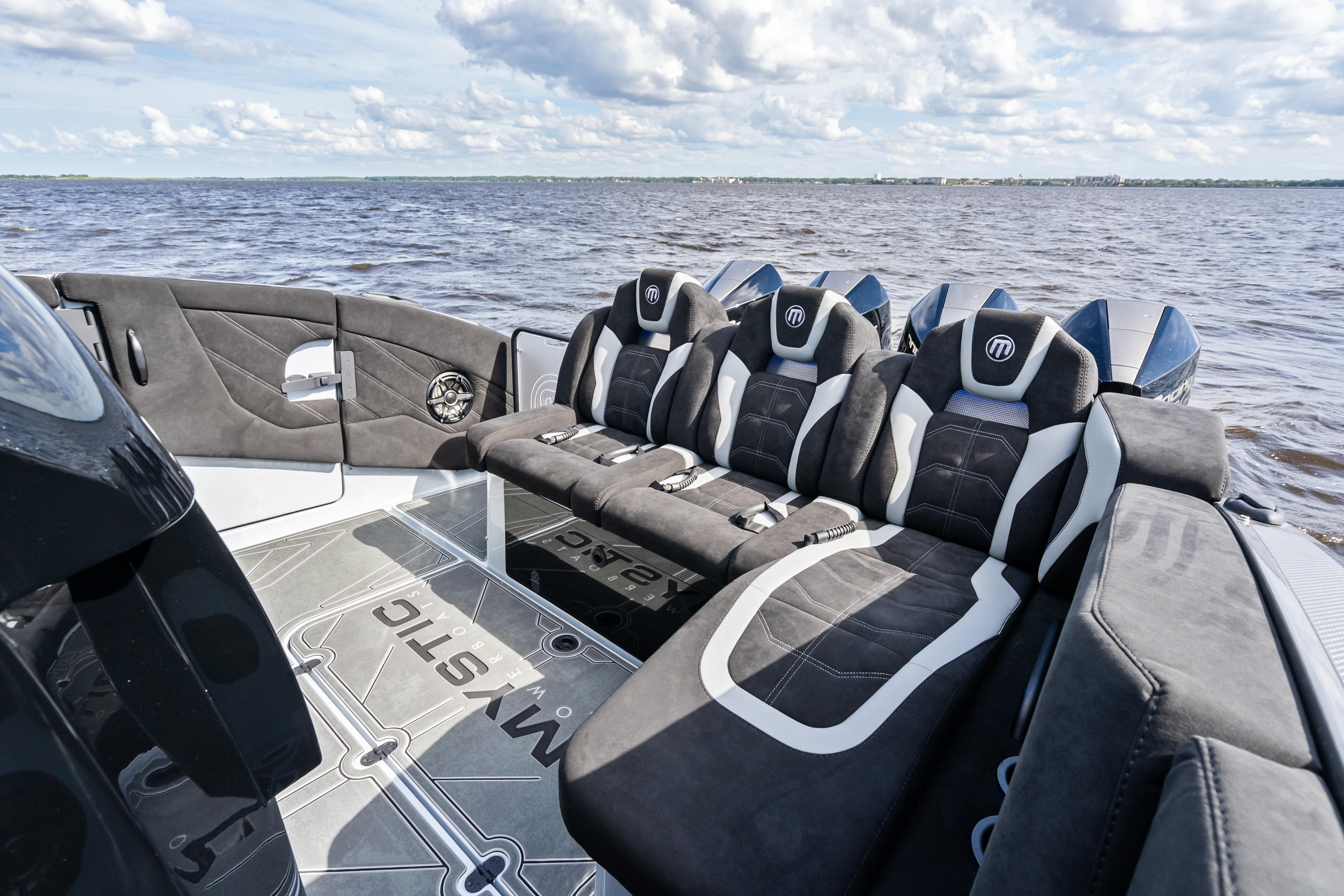 2027 Mystic Powerboats M4200 luxury seating on open water, showcasing sleek design and comfort.