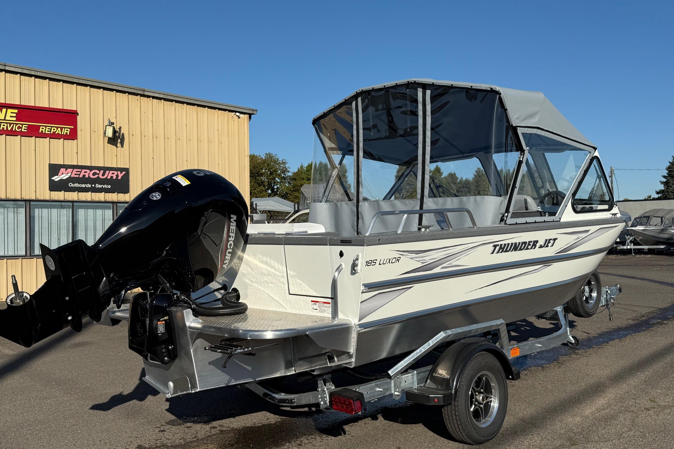 2026 Thunder Jet 185 Luxor boat with Mercury outboard motor, parked outside service center.