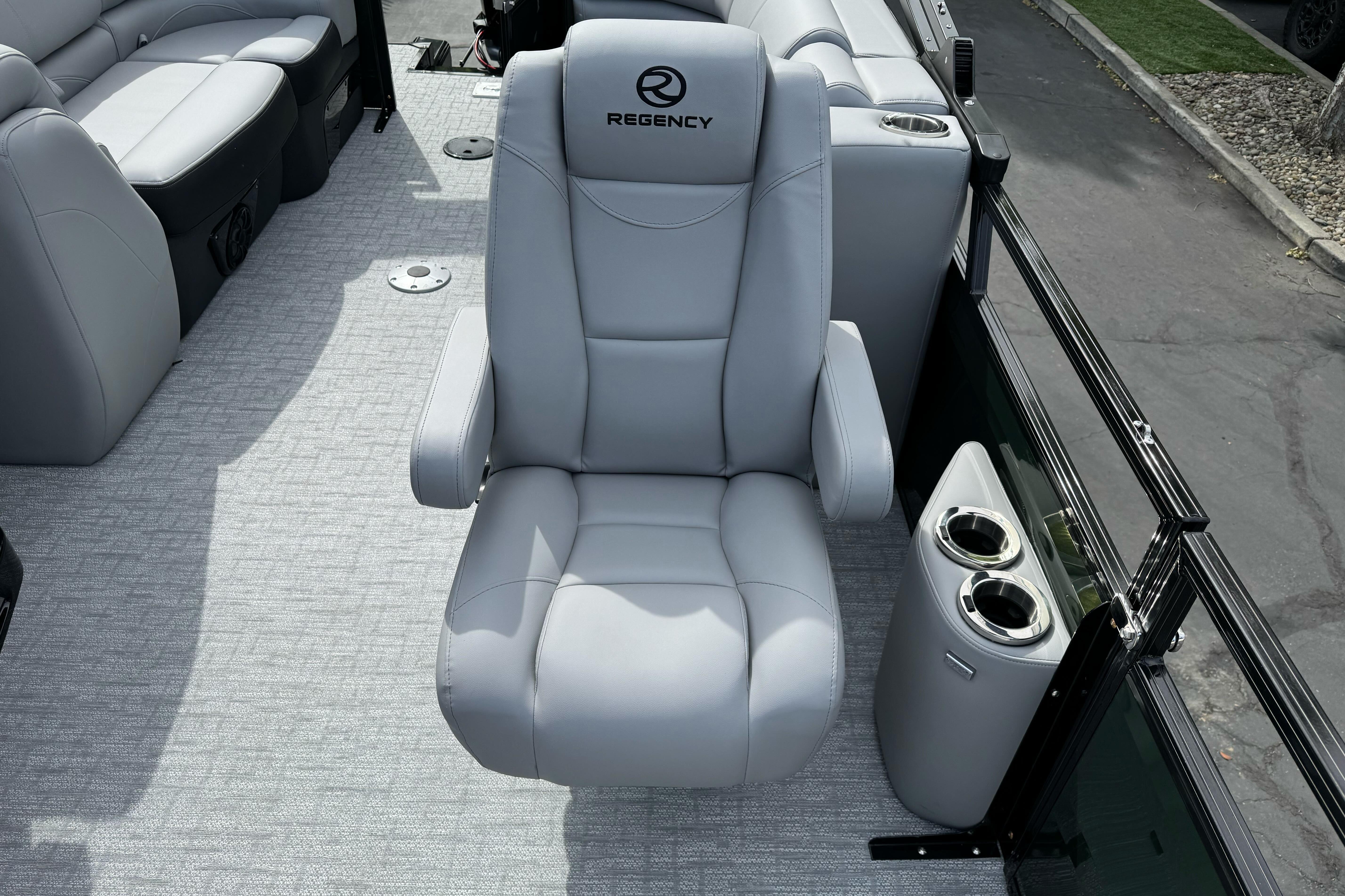 Luxurious seating on 2026 Regency 250 DL boat with cup holders and sleek design.