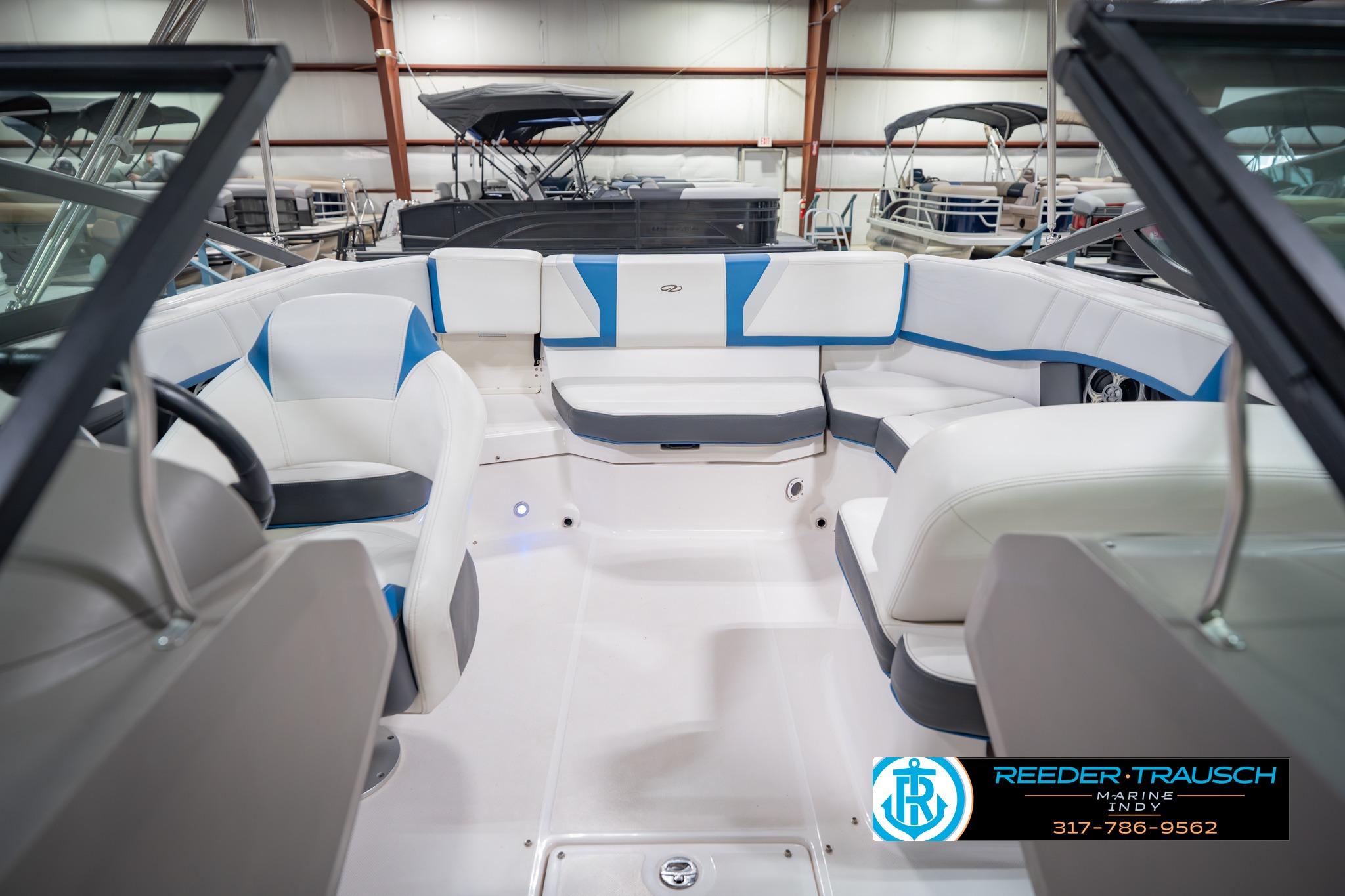 2015 Regal 2000 ESX Bowrider interior with white and blue seating in showroom.