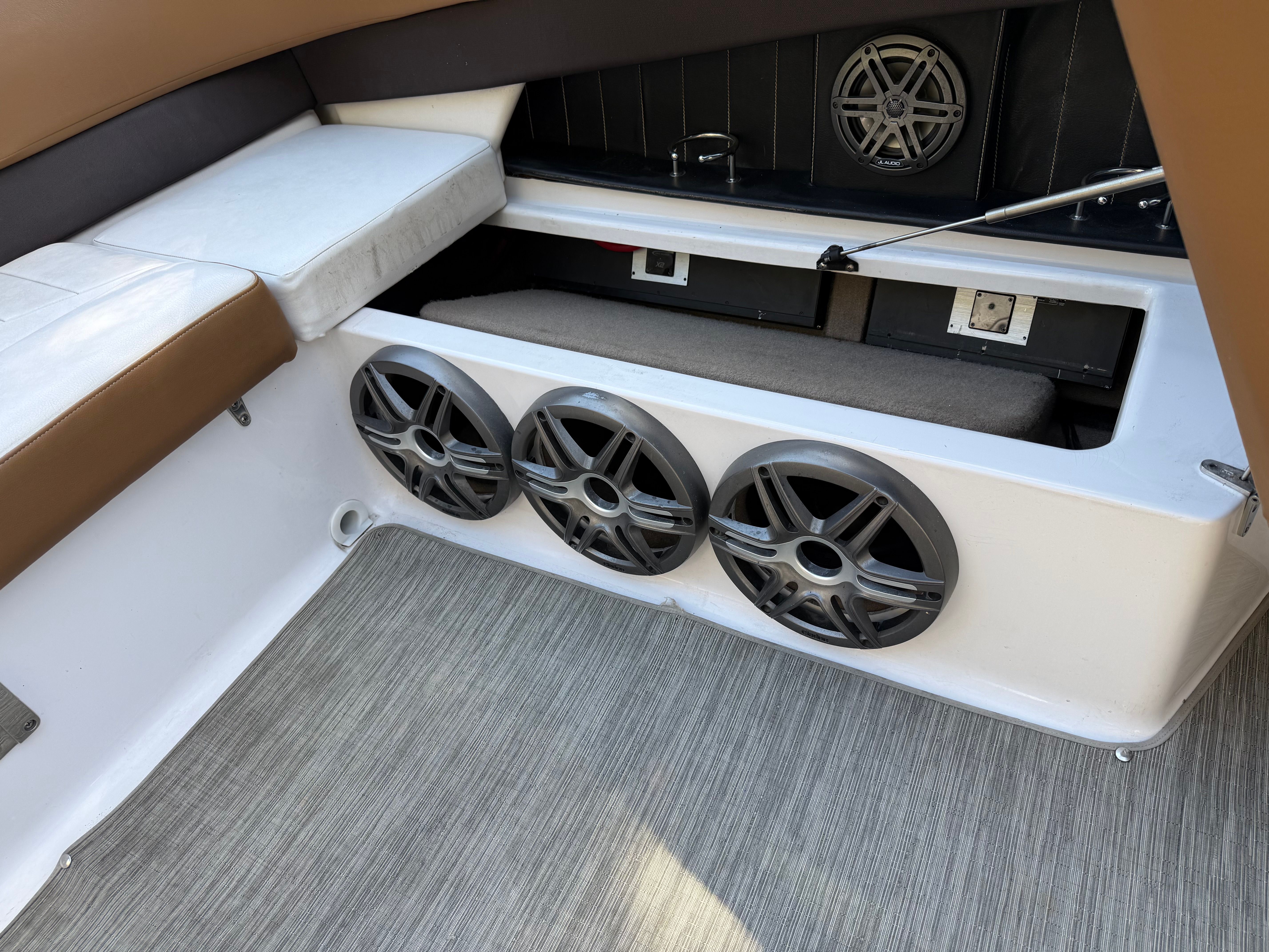 Interior of a 2019 Four Winns H260 boat with speakers.
