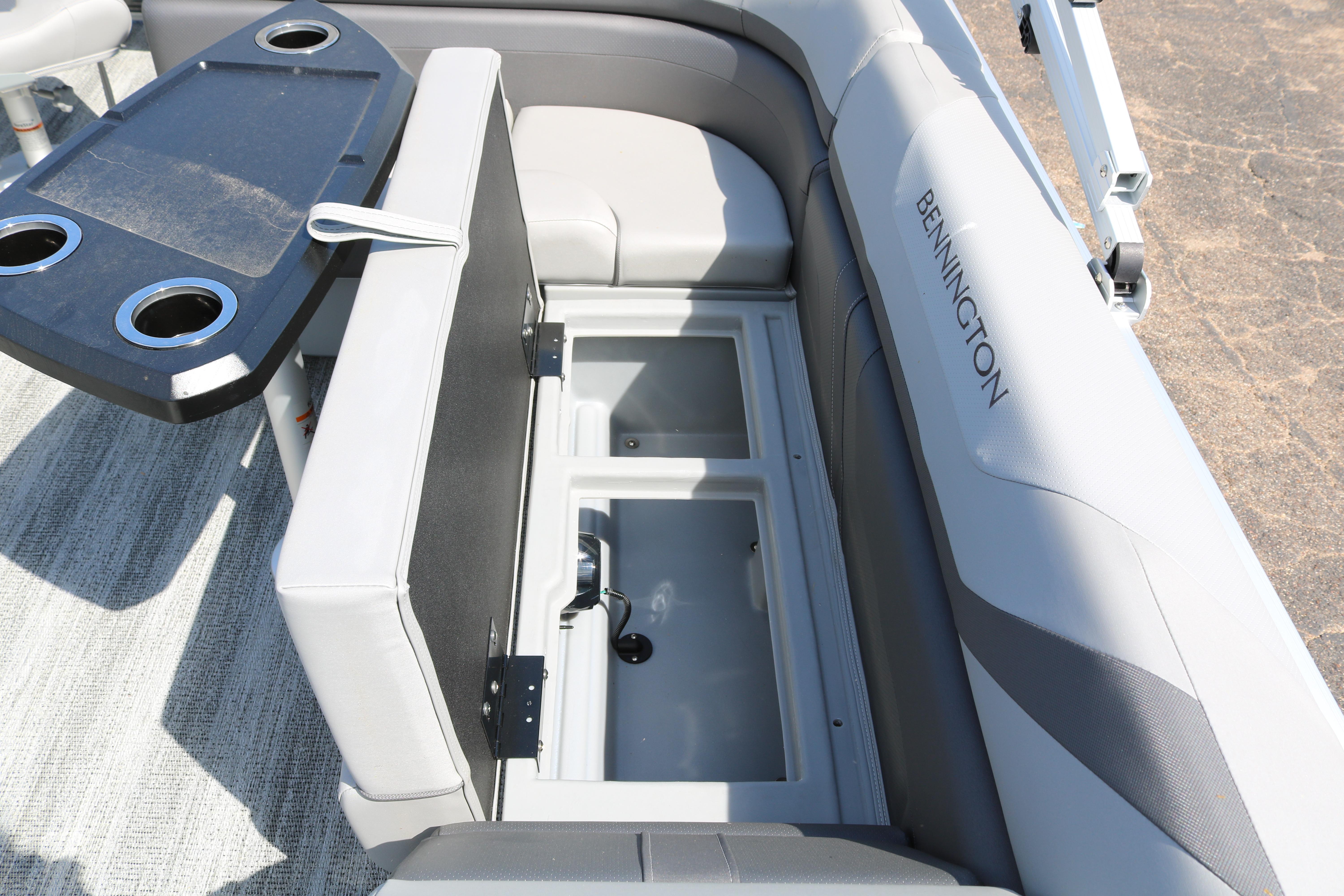 2026 Bennington 20SXSNP boat interior with storage compartments and cupholders.