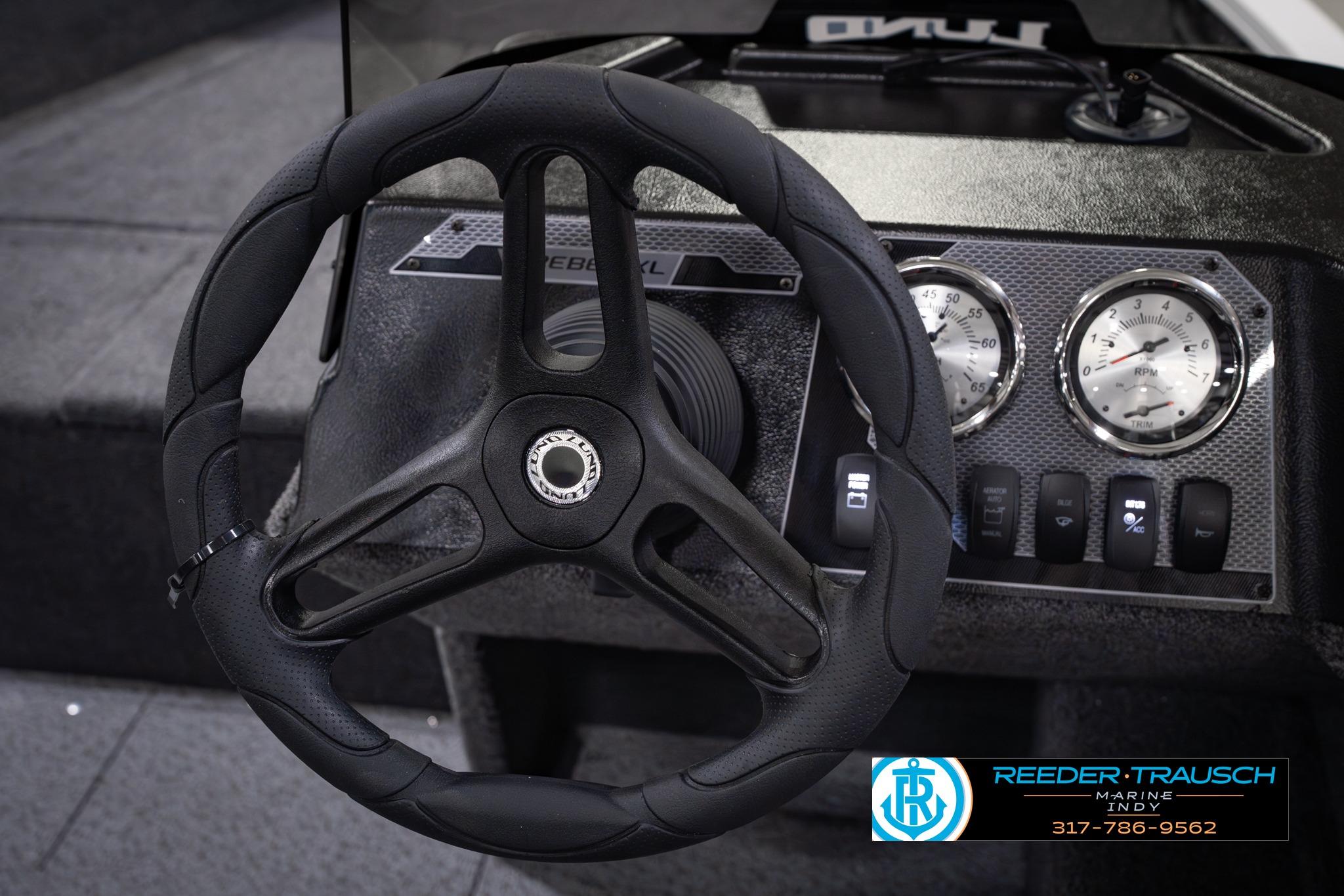 Steering wheel and dashboard of 2026 Lund 1650 Rebel XL SS boat, featuring gauges and controls.