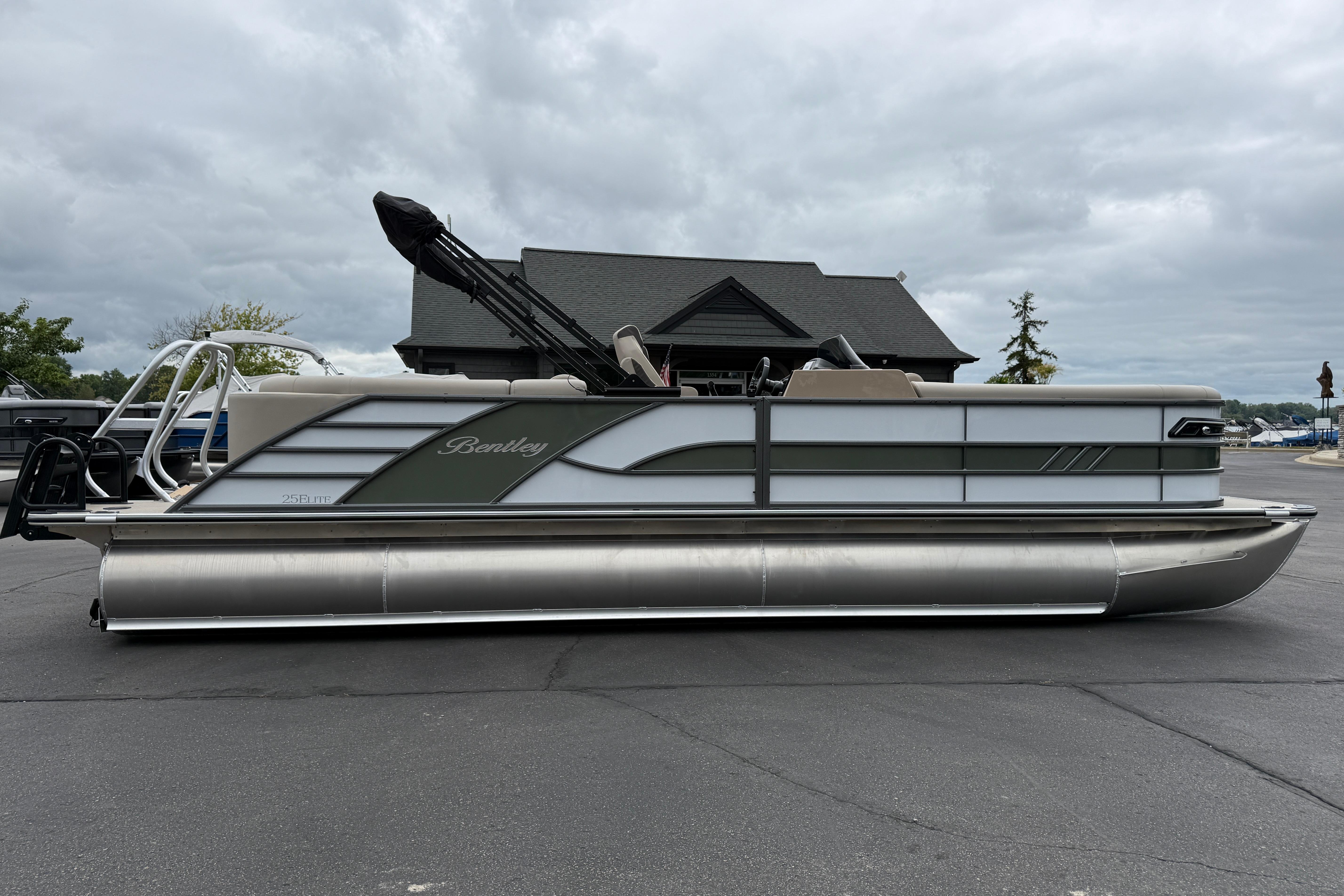 2026 Bentley Pontoons Elite 253 Admiral pontoon boat parked outdoors.