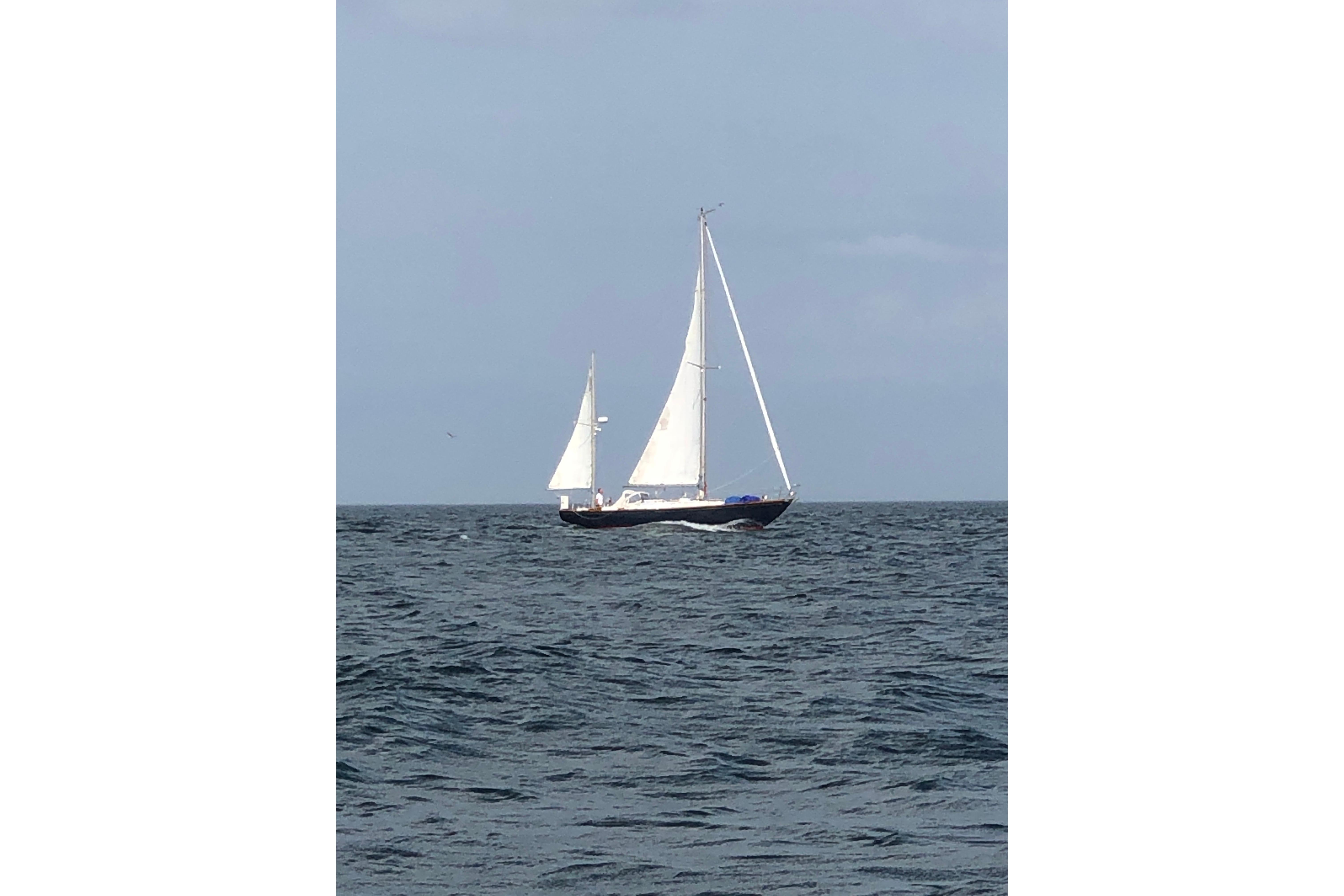 1970 Hinckley Bermuda 40 sailboat navigating open sea under clear skies.