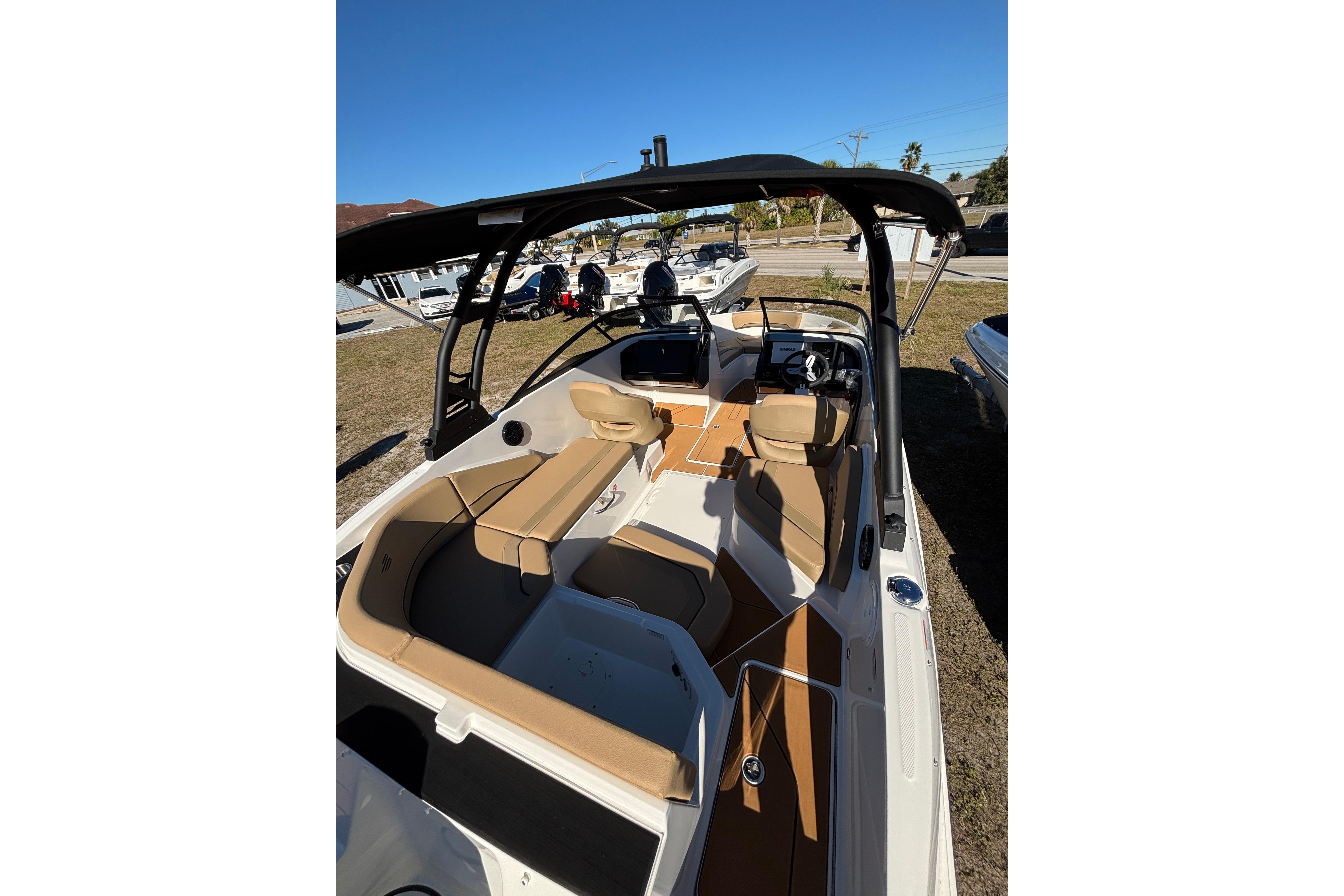 2025 Bayliner V20 boat interior with tan seating and modern dashboard.