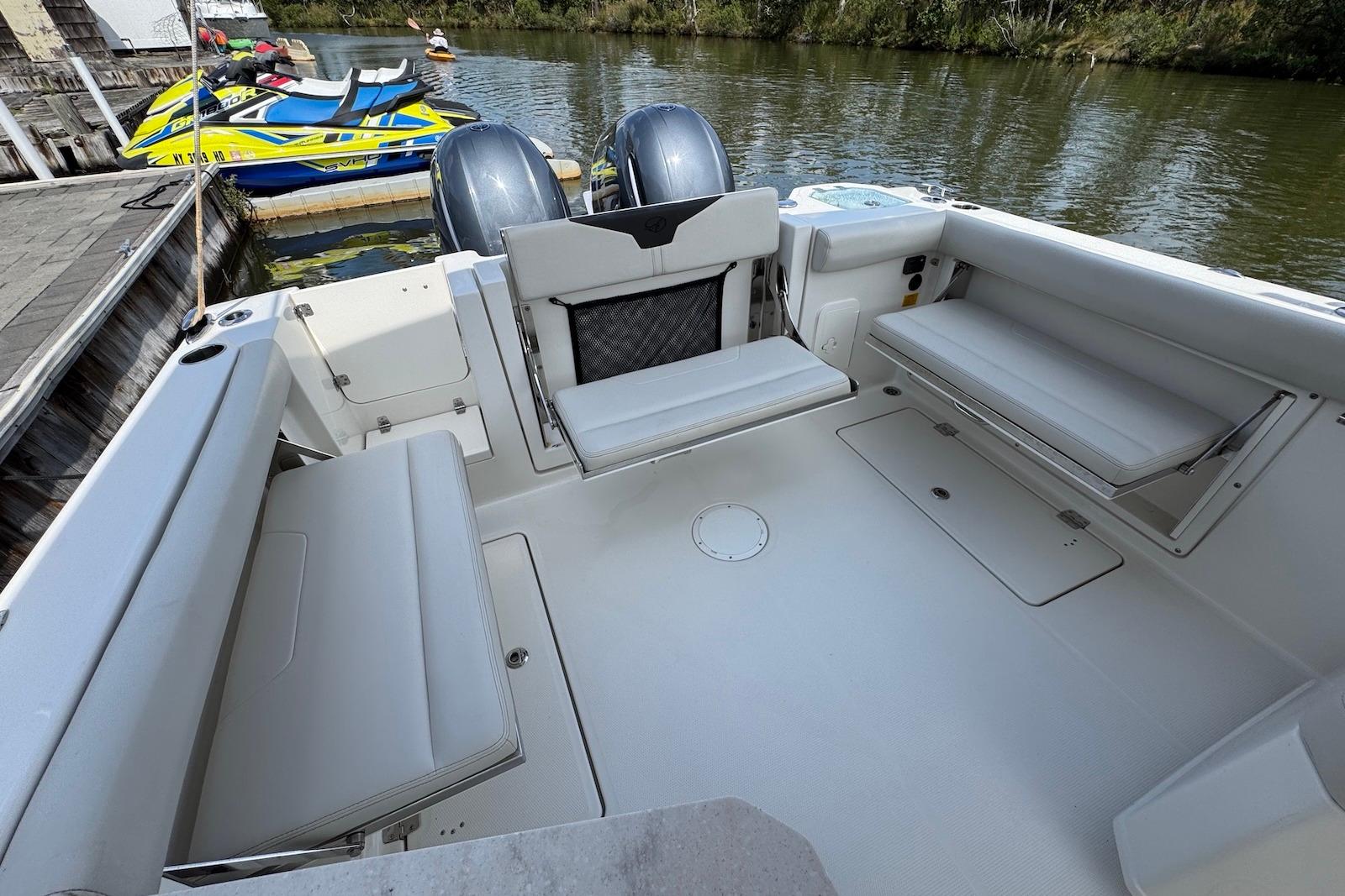 2022 Sailfish 276 DC boat interior with seating, docked by water.