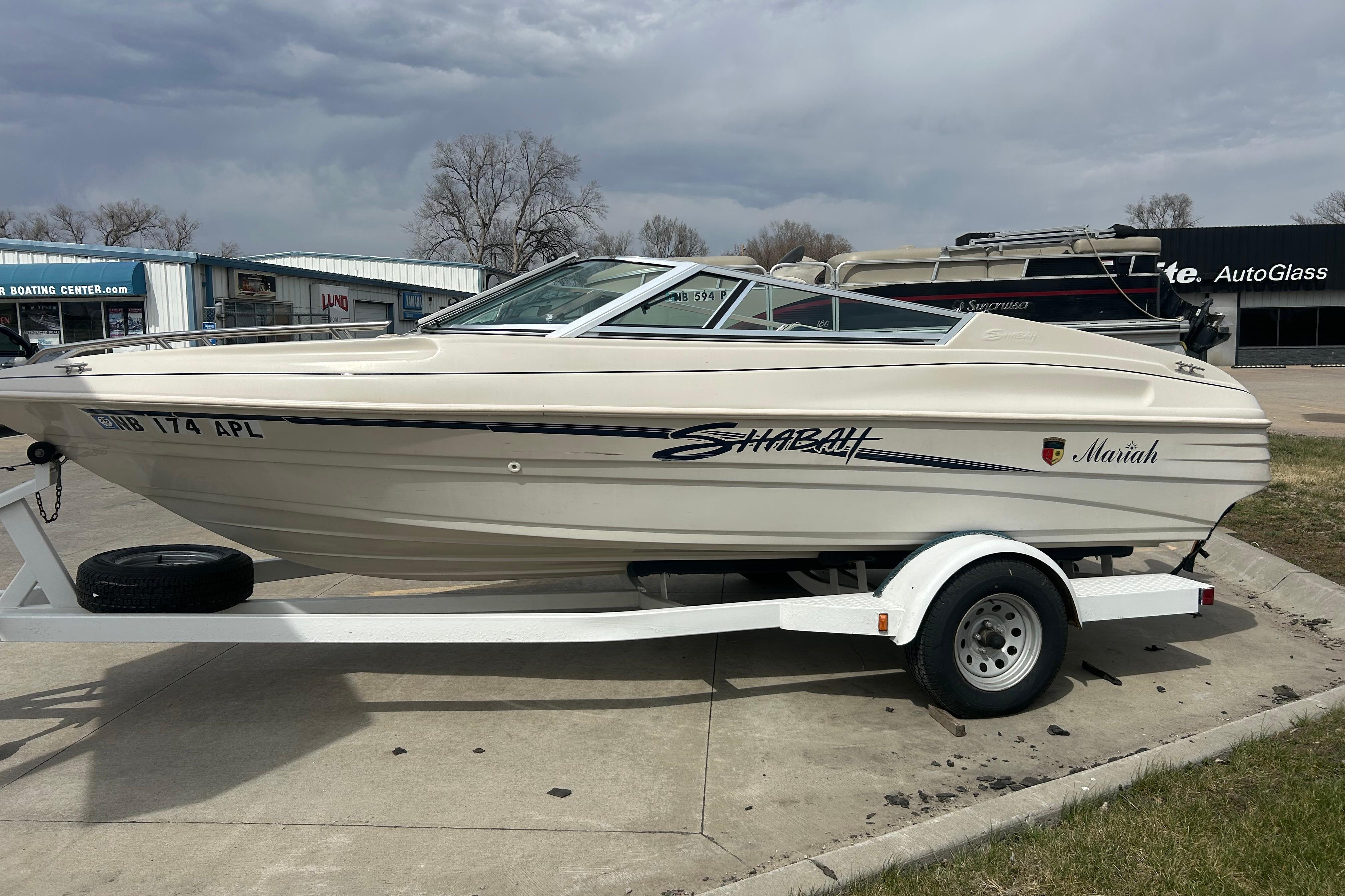 1996 Mariah 180 Shabah boat on trailer, parked outdoors under cloudy sky.