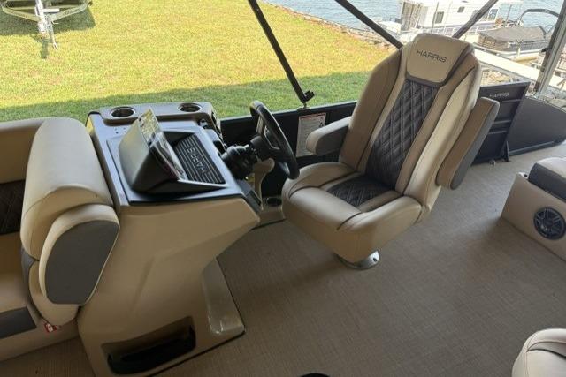 2025 Harris Sunliner 230 boat interior with luxurious seating and modern helm controls.