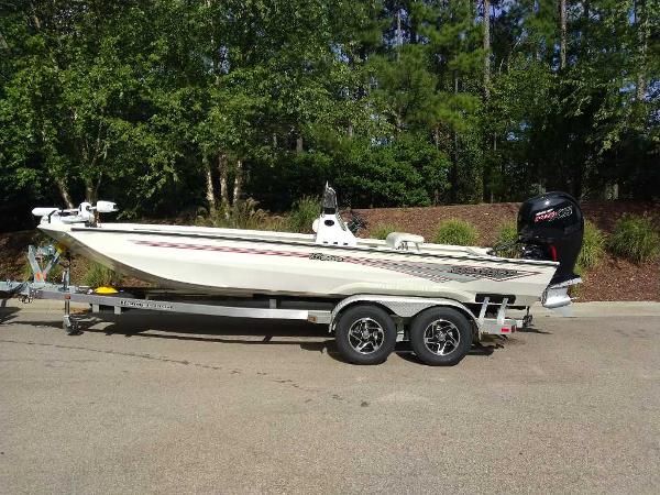 2024 Ranger RB200 boat on trailer, parked outdoors, surrounded by trees.