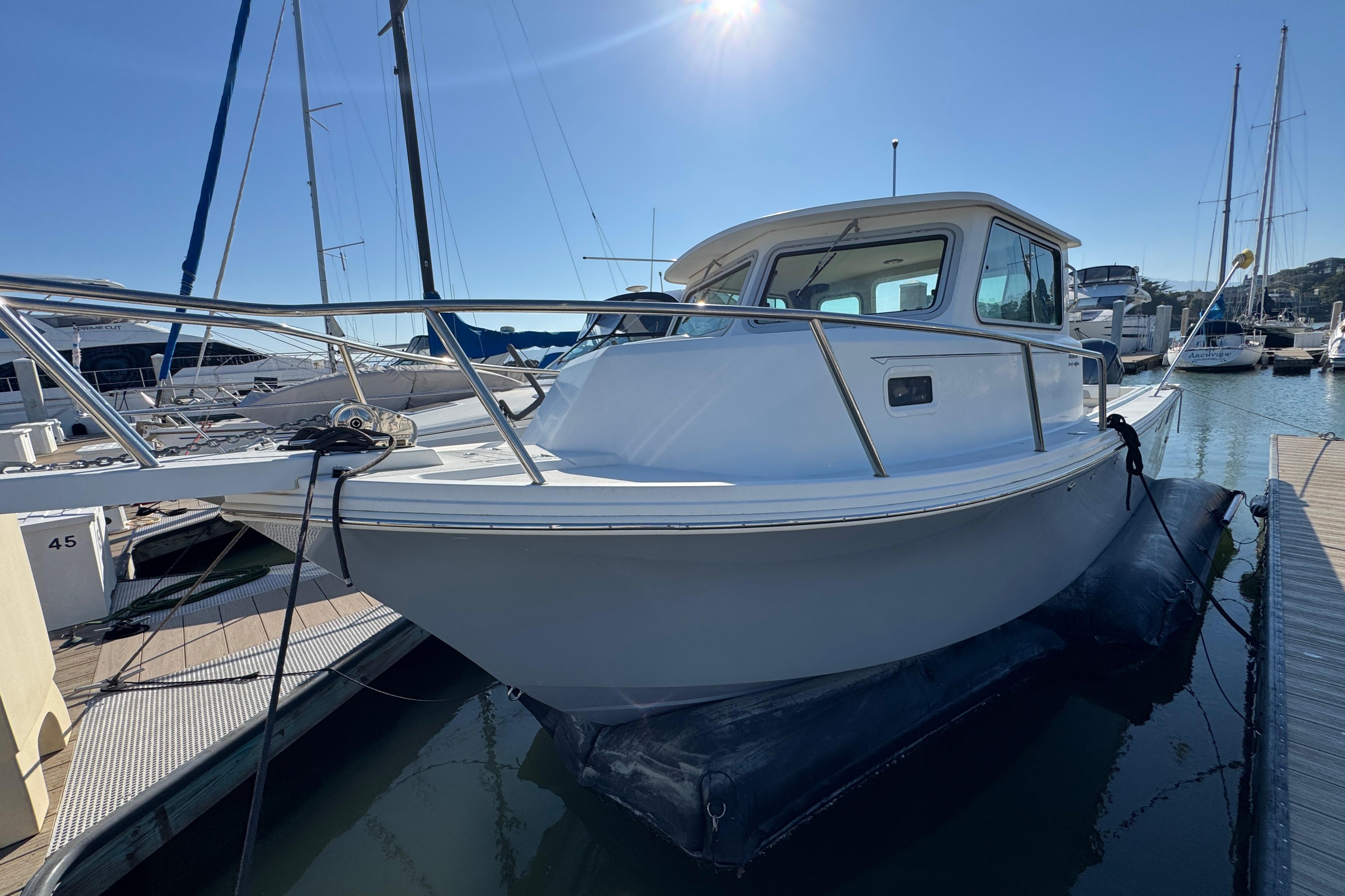 2021 Parker 2820 XLD Sport Cabin boat docked in a marina under clear blue skies.