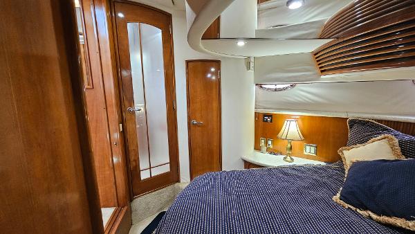 Interior of 2000 Carver 450 Voyager Pilothouse with cozy bedroom and wooden accents.