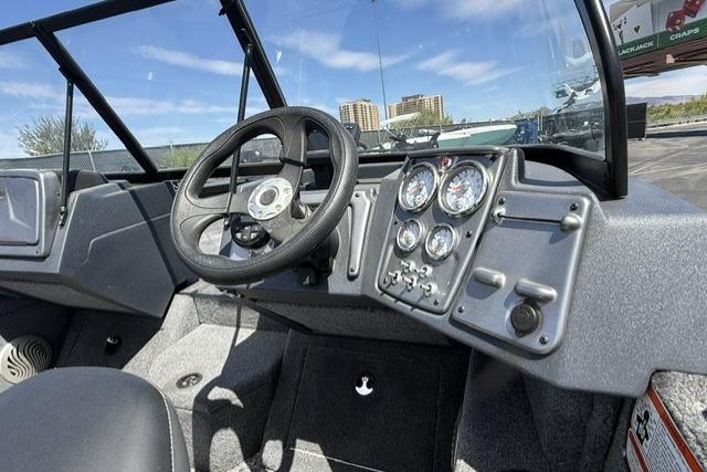 2025 Tracker Pro Guide V-175 WT boat dashboard with steering wheel and gauges.