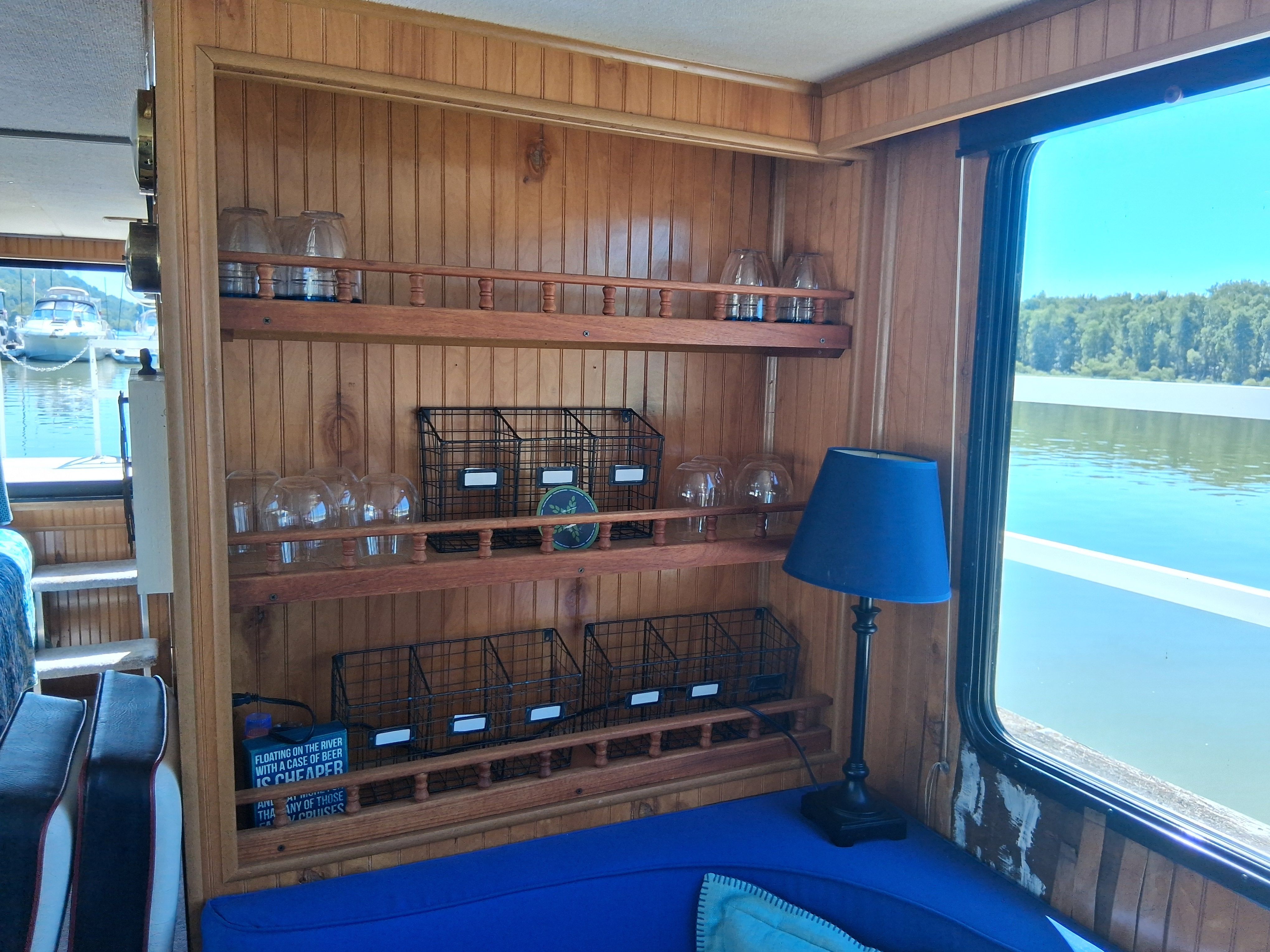 Interior of a 1993 Gibson 370 Sport with wooden walls and blue upholstery.