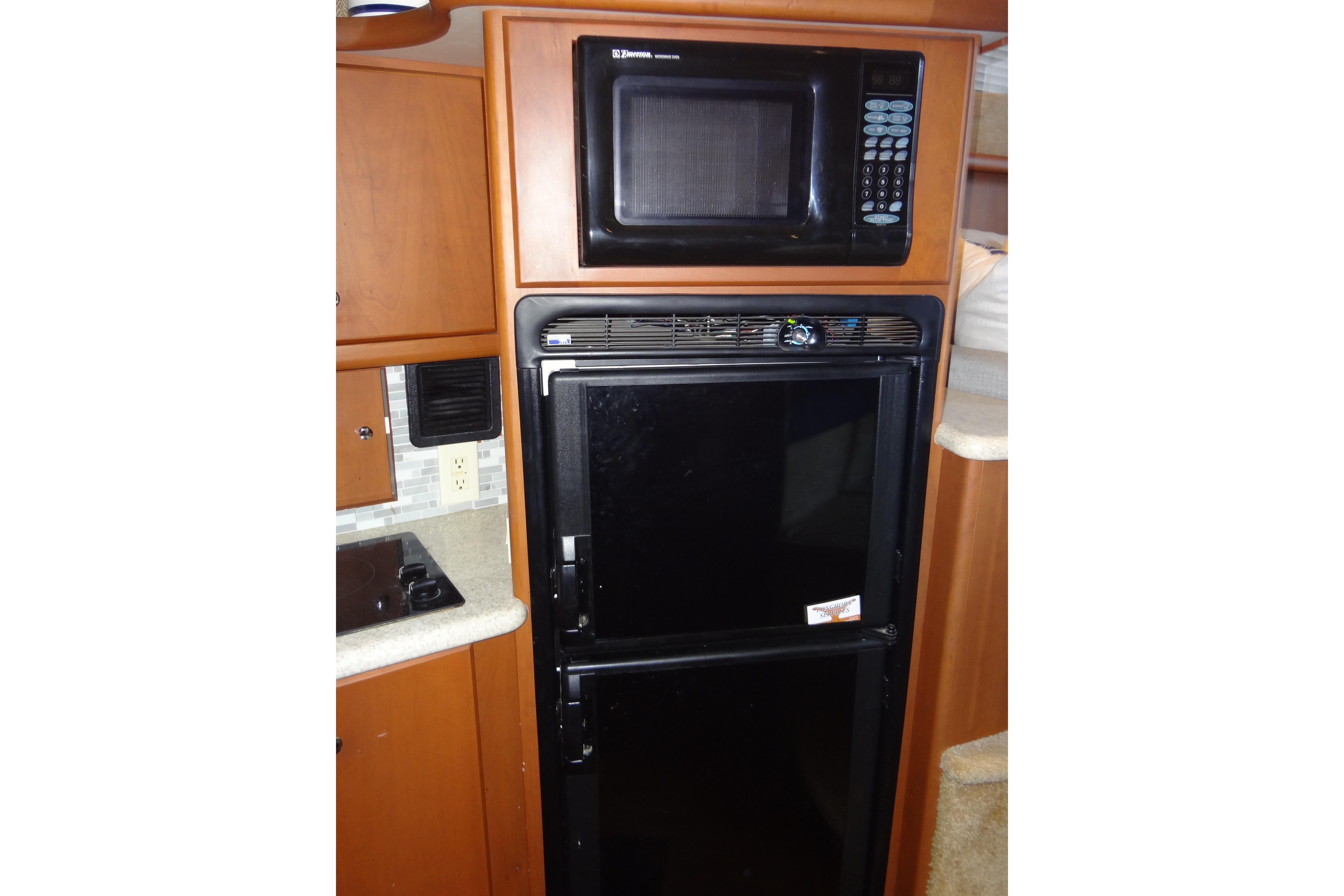 Microwave and fridge in 2005 Silverton 34 Convertible yacht kitchen.