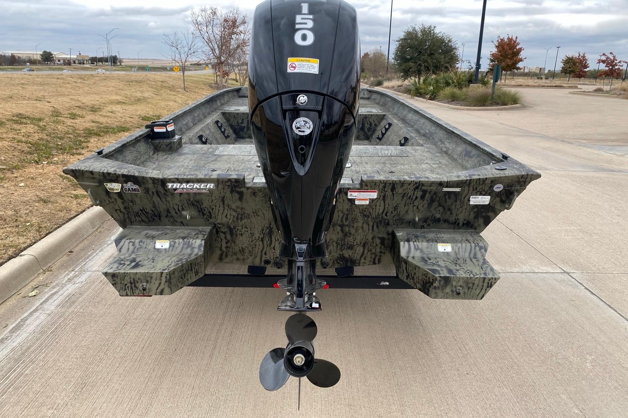 2026 Tracker Grizzly 2072 CC boat with camo design and powerful outboard motor.