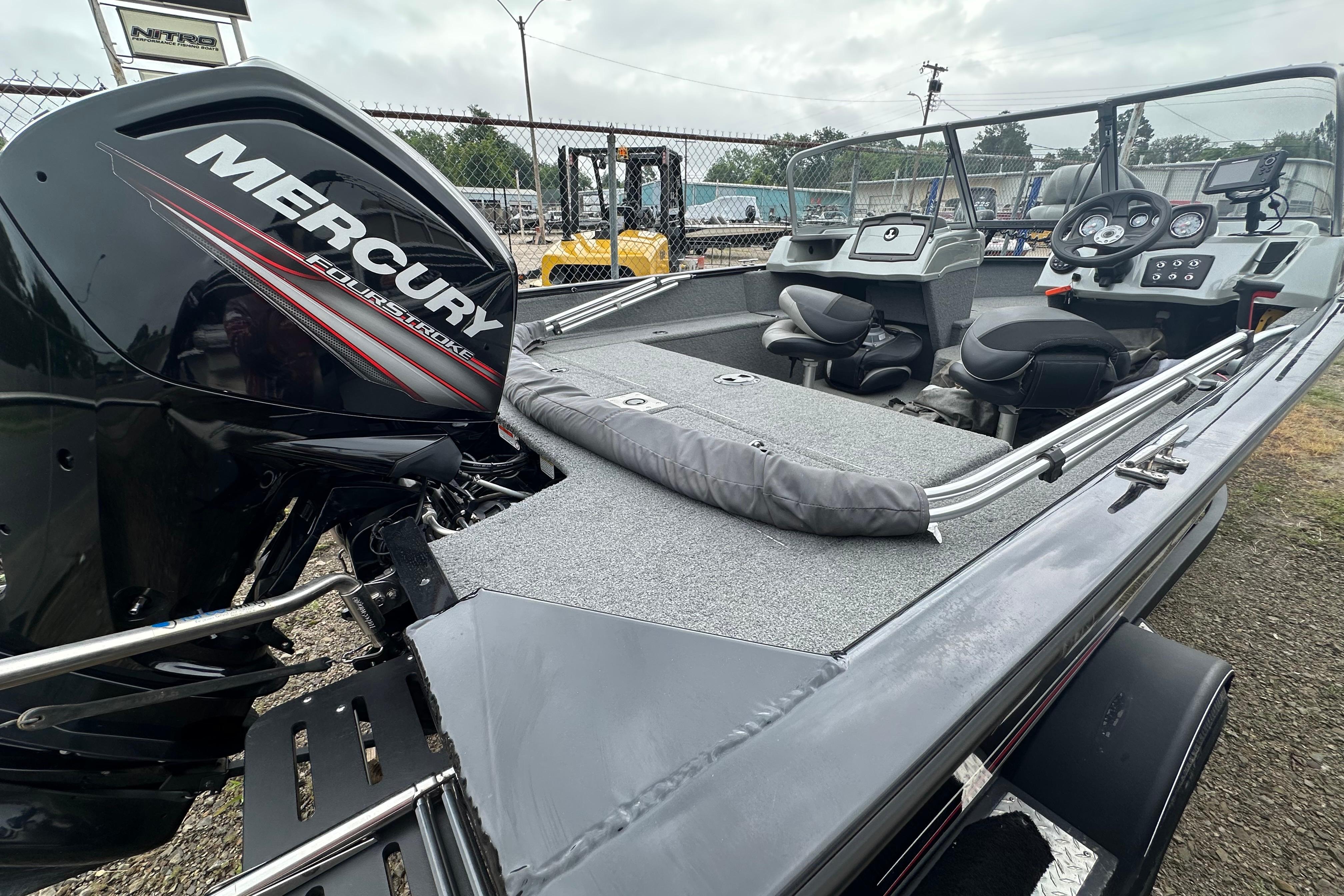 2018 Tracker Pro Guide V-175 Combo boat with Mercury FourStroke engine, parked outdoors.