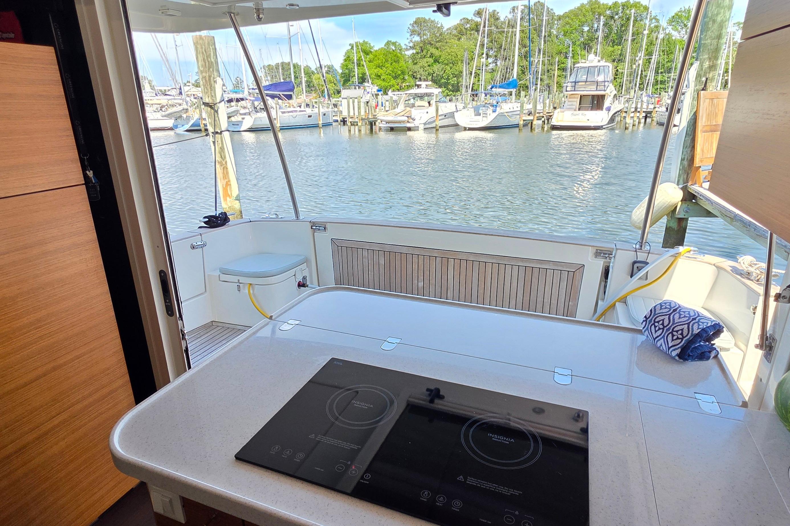 Interior view of 2023 Greenline 40 yacht with marina backdrop.