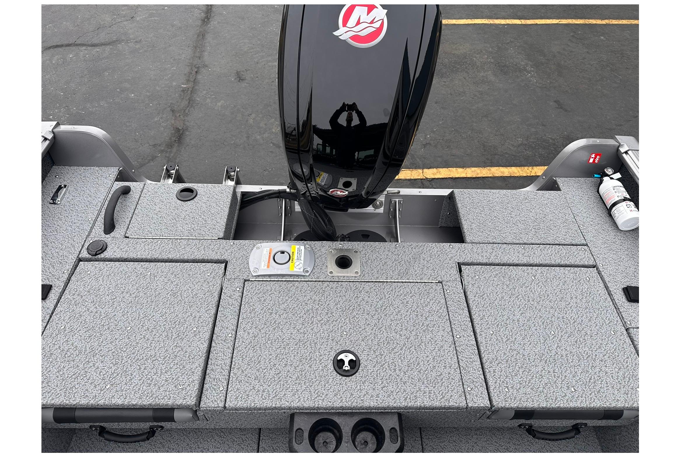 2026 Lund 1775 Impact XS Sport boat deck with motor and storage compartments.