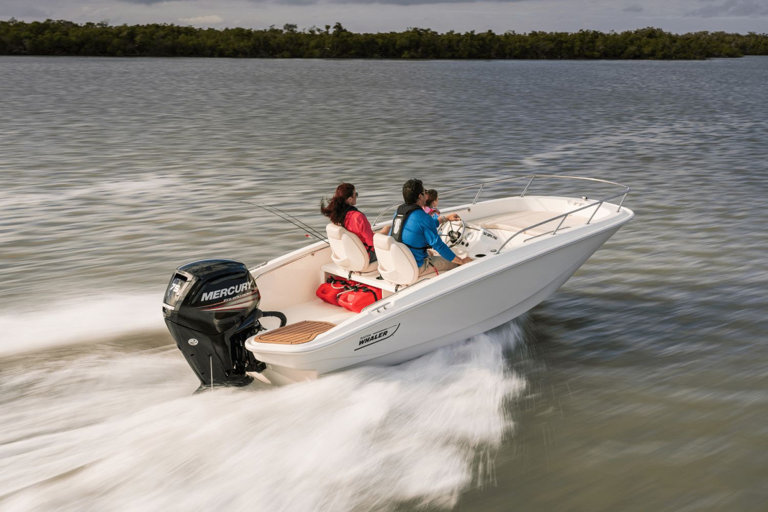 Three people ride a Boston Whaler 160 Super Sport across the water.