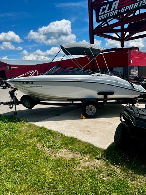 2023 Yamaha SX190 boat on a trailer, featuring a sunshade, parked in a lot.