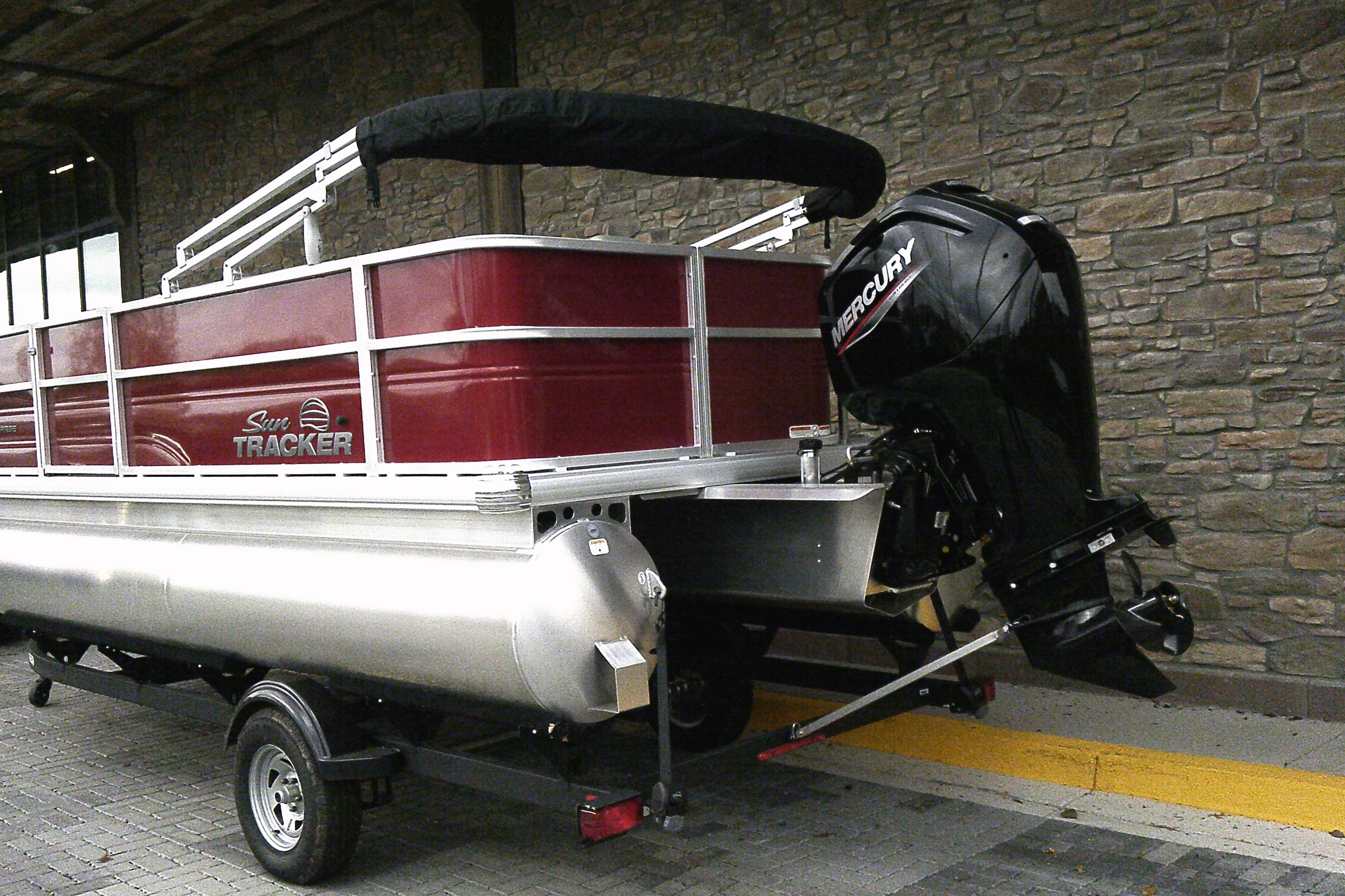 2026 Sun Tracker Party Barge 18 DLX pontoon boat with Mercury outboard motor.