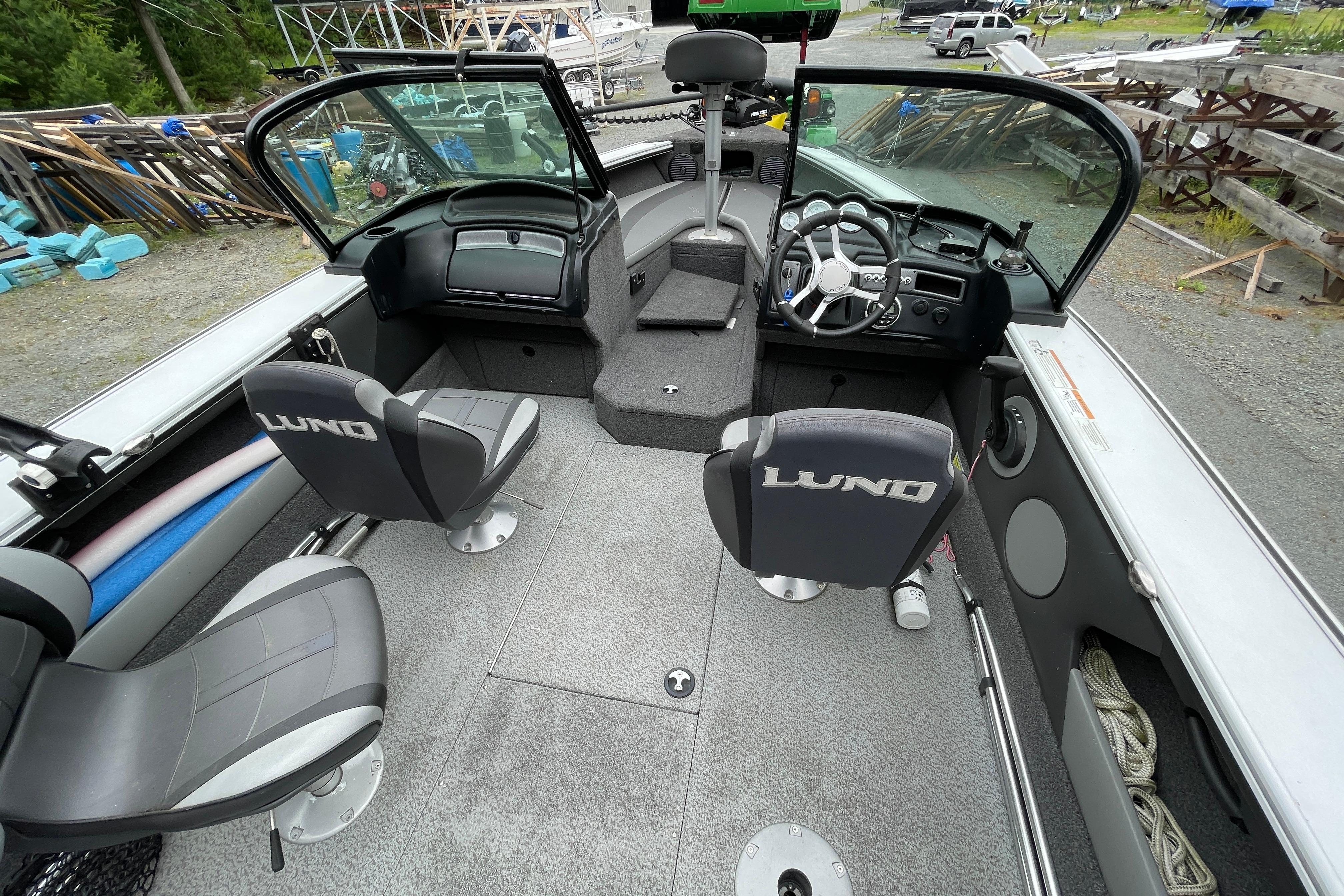 2022 Lund 1875 Crossover XS boat interior with steering wheel and seating.