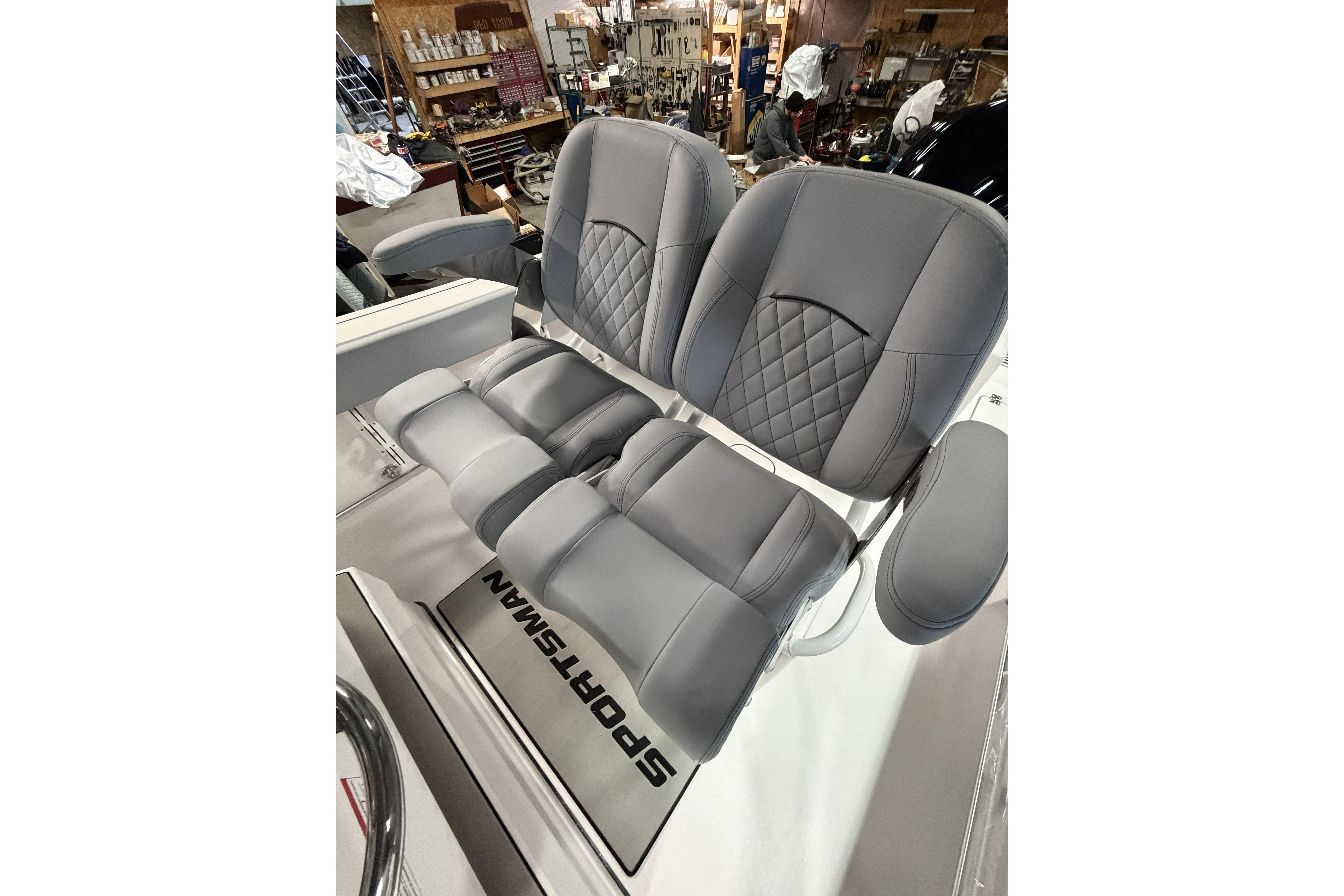 2026 Sportsman Open 232 Center Console boat seats in a workshop setting.