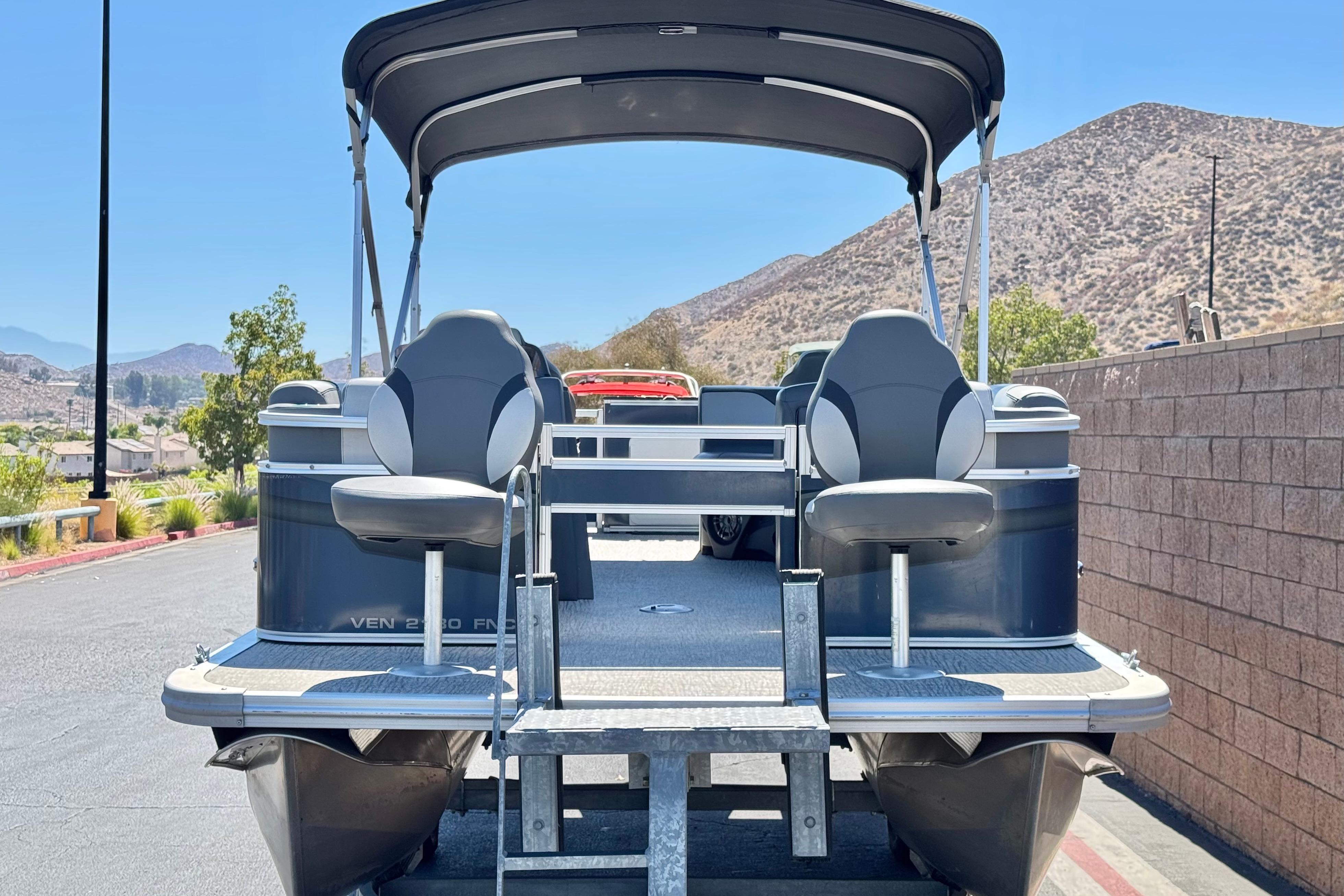 2023 Avalon Venture Fish N Cruise 20' pontoon boat with canopy, parked outdoors.