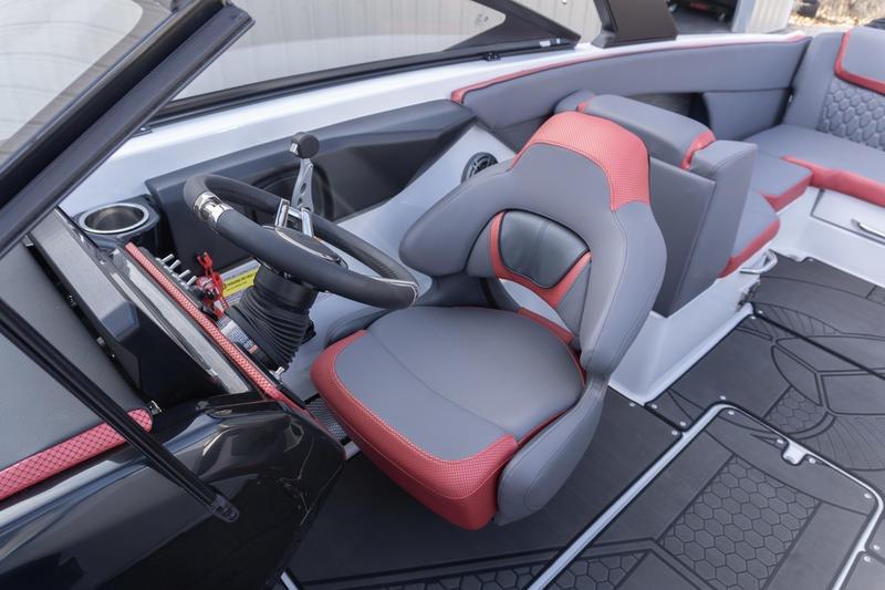 2026 Scarab 255 LX Wake boat interior with red and gray seating, steering wheel, and modern design.