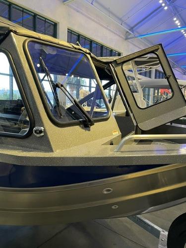 2024 Spartan 185 Astoria boat on display in a showroom.