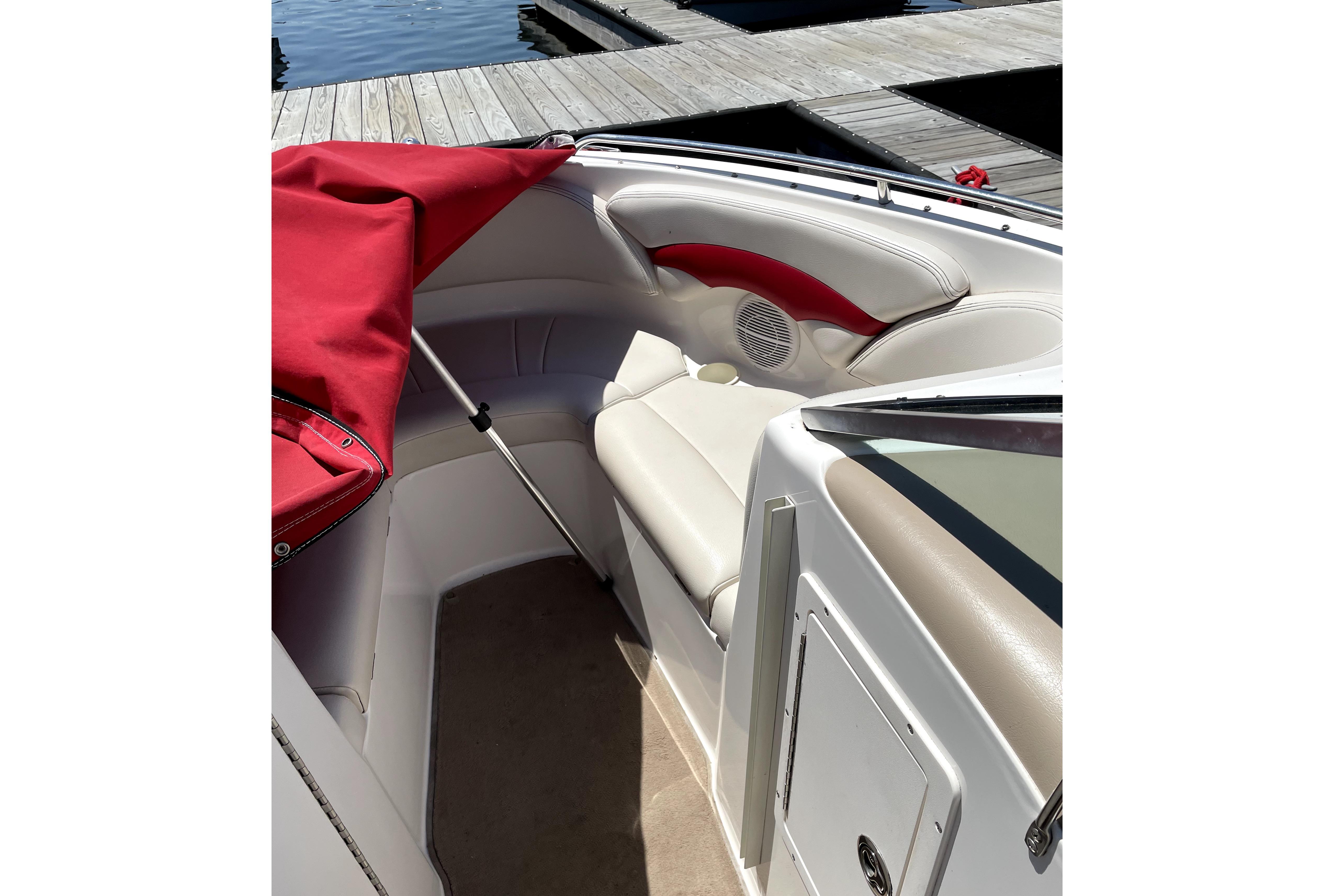 2003 Chaparral 200 SSi boat interior with red and white seating, dockside view.